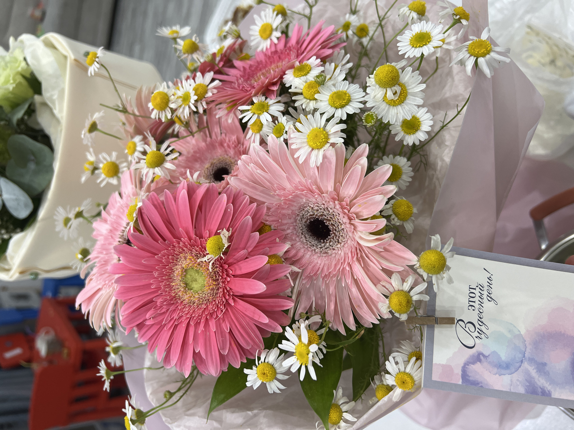 Pink and white flower bouquet with Russian celebration card
