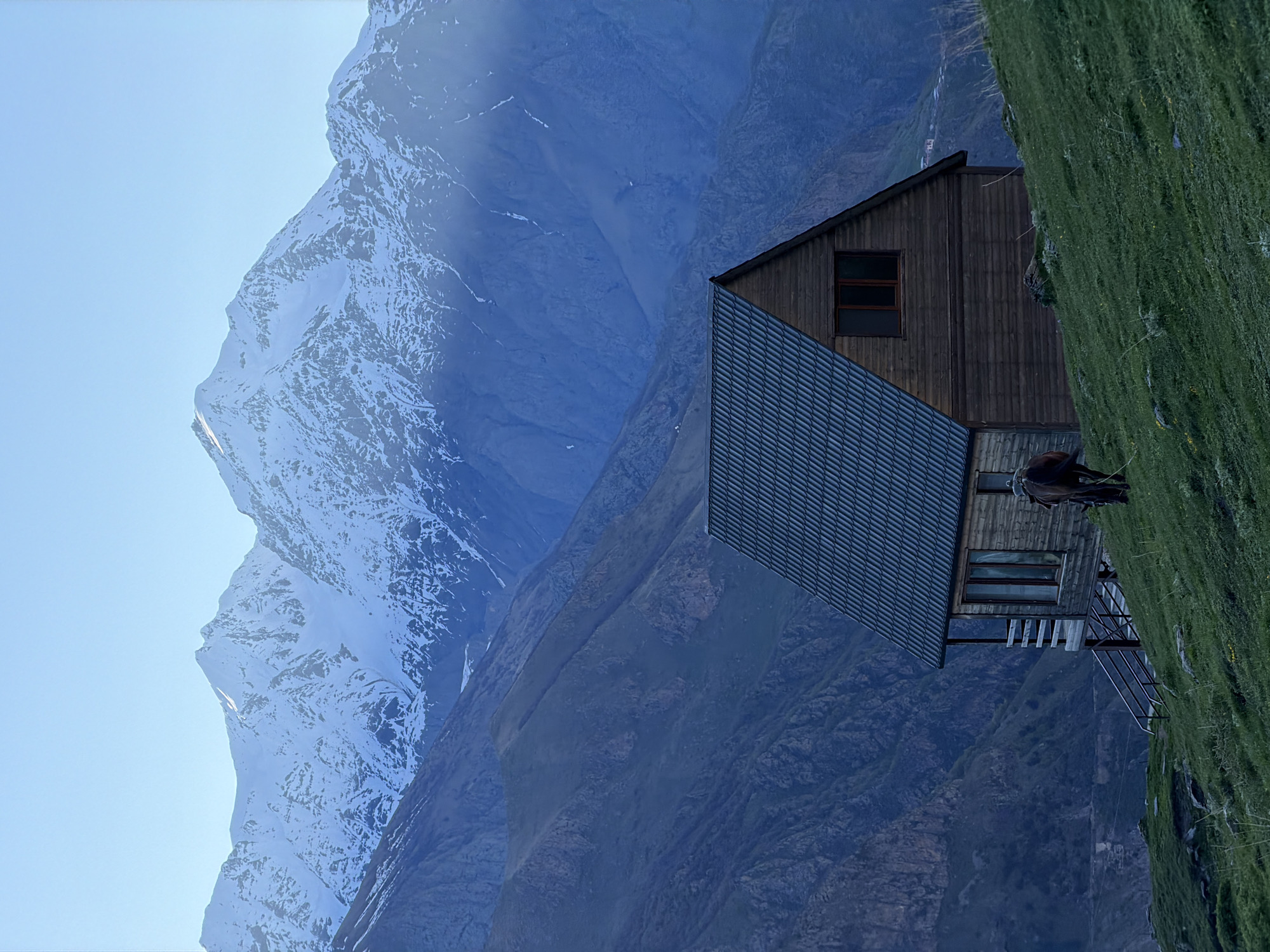 Person, horse spotted near mountain building in Stepantsminda, Georgia