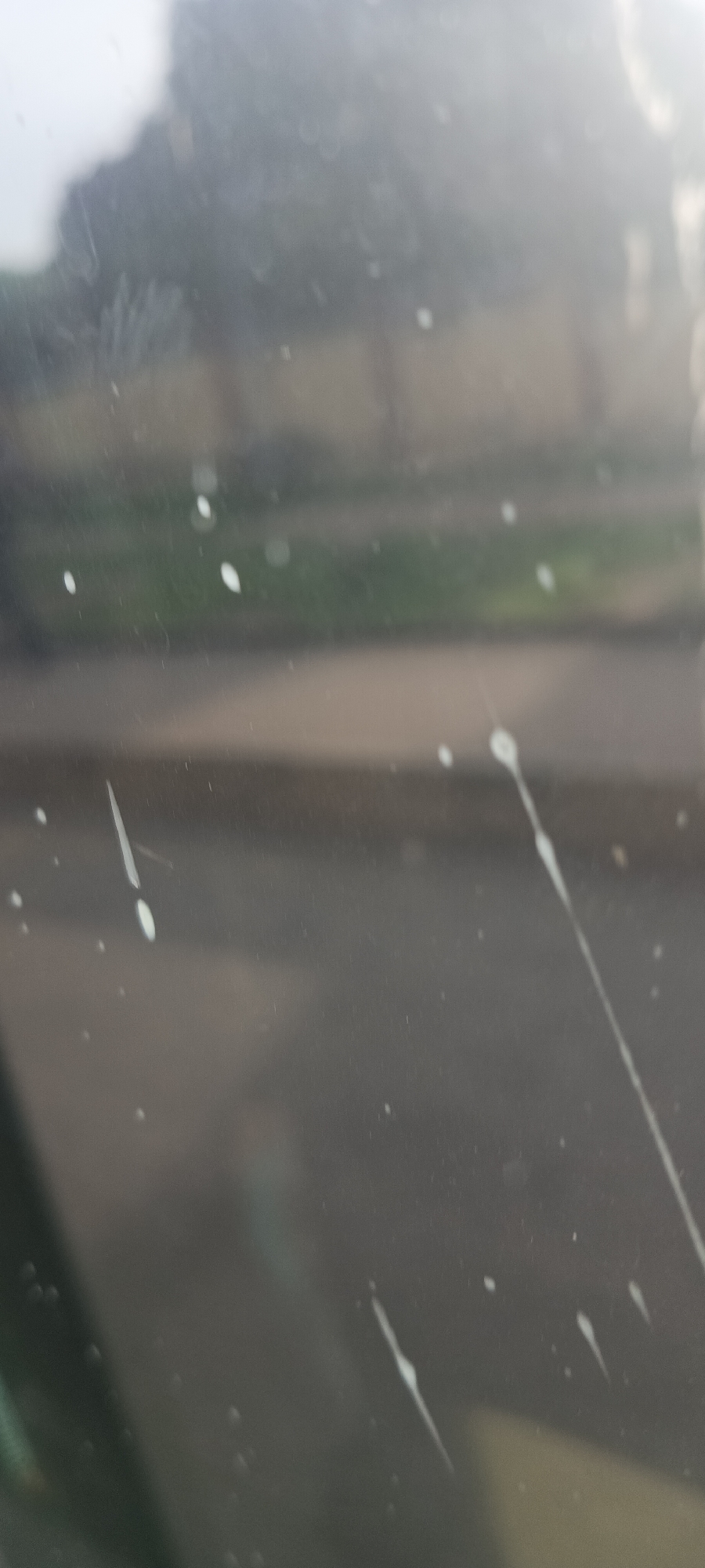 Dirty vehicle windows obscure Jos street scene views