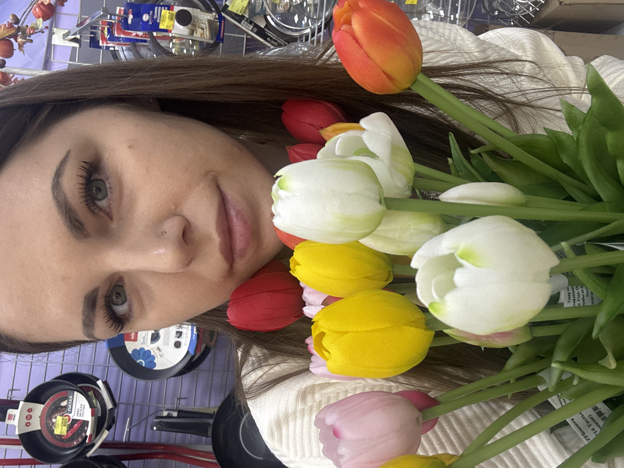 Woman takes selfies with artificial tulips in Klin store