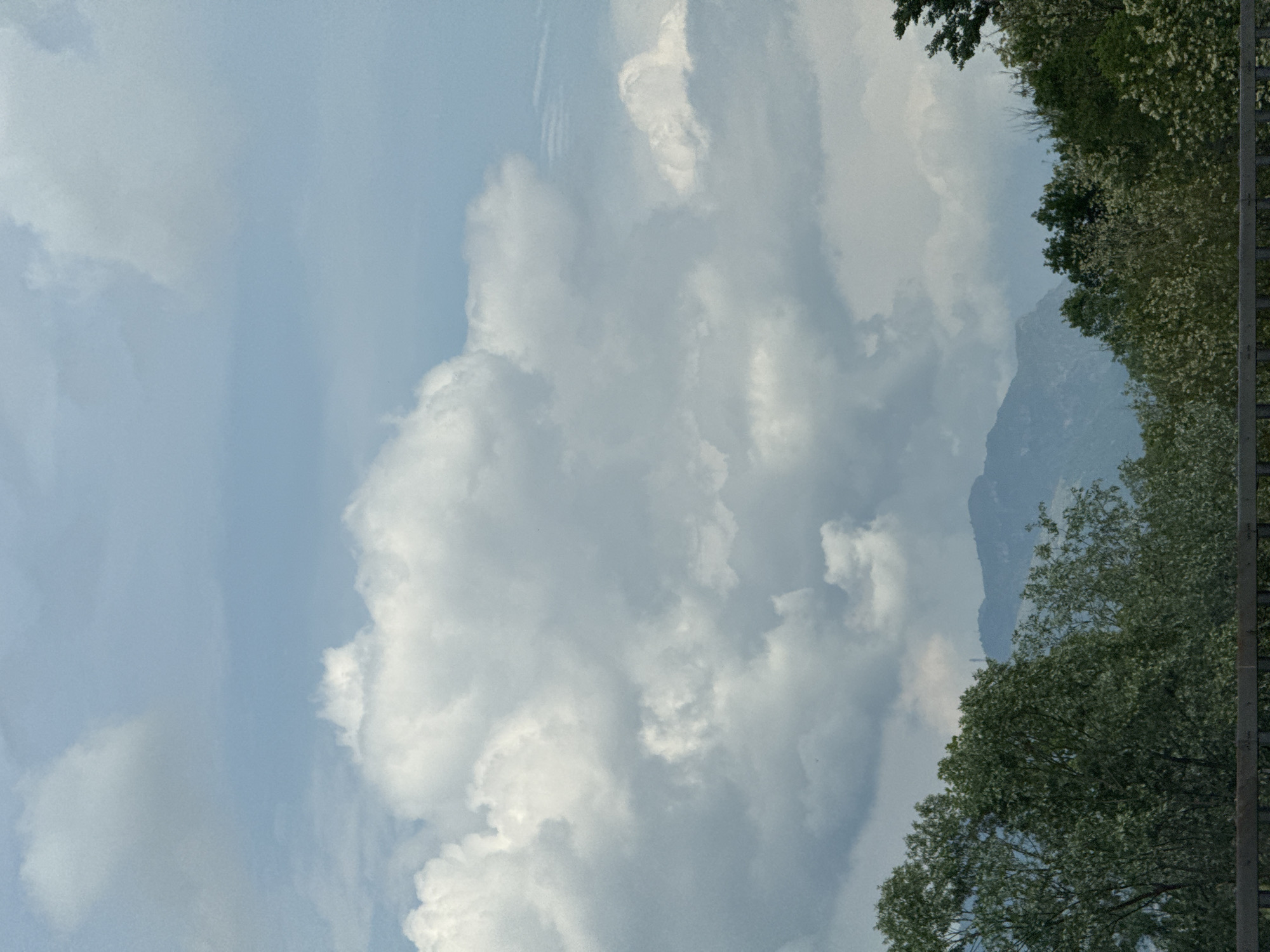 Partly cloudy mountain landscape observed in Briosco, Italy