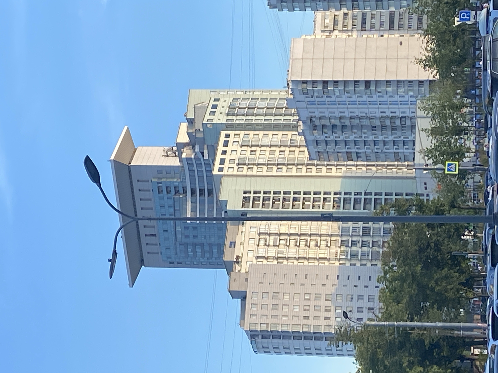 Modern residential towers line a Moscow street on a clear day