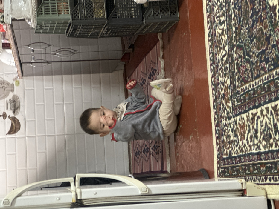 Father documents morning routine with baby in Uzbekistan home