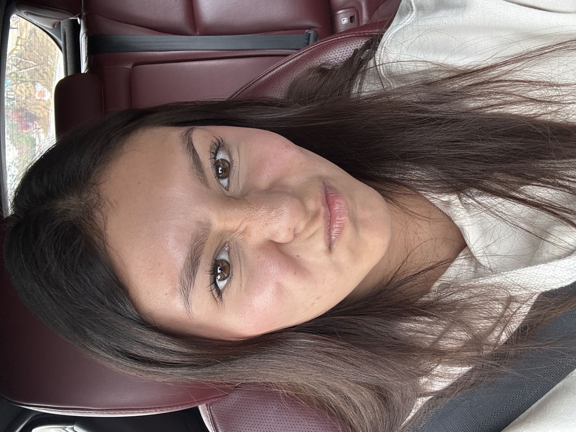 Woman poses playfully in car in Oaxaca City