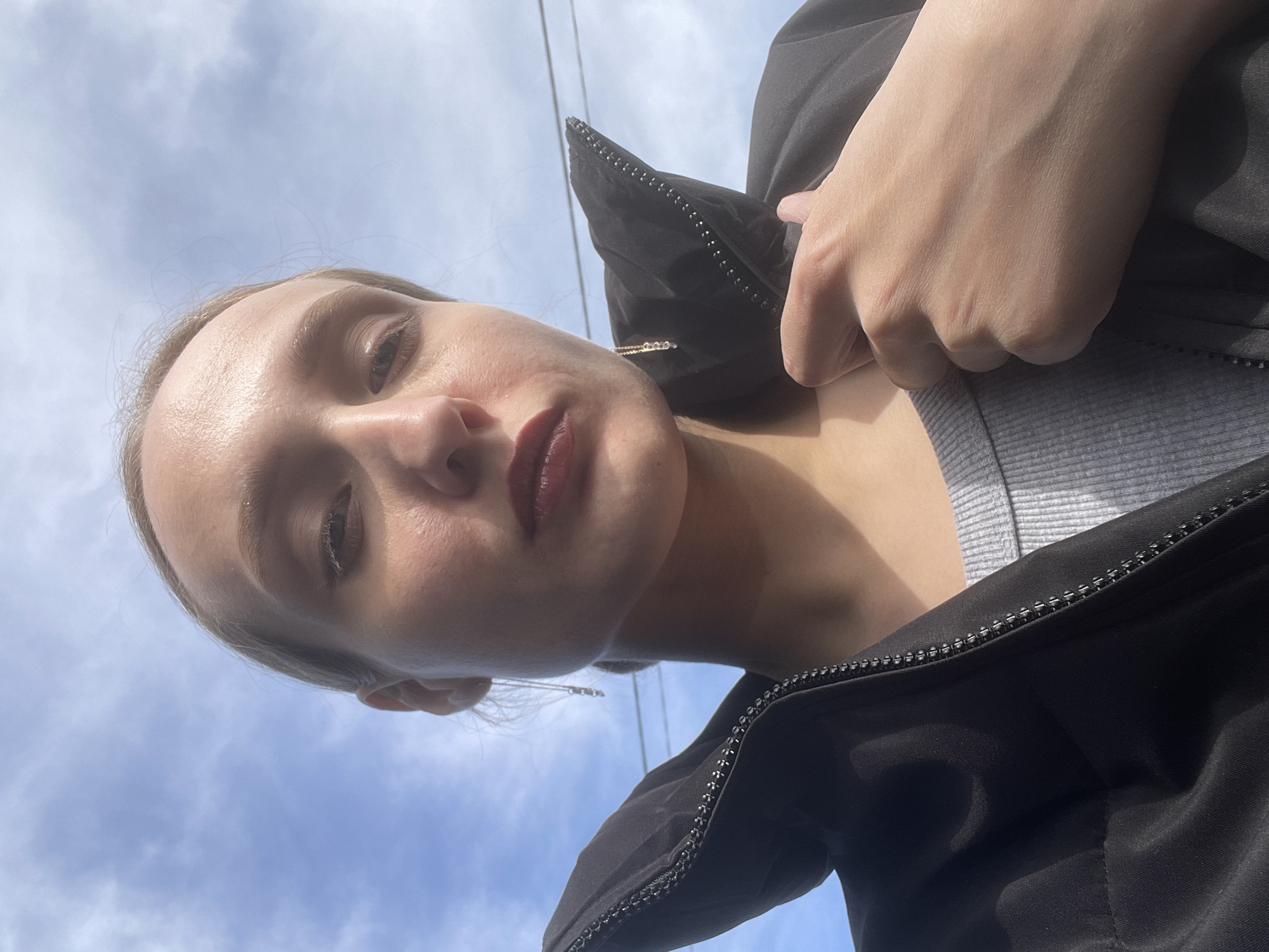 Woman takes selfie, tulips bloom in Russian village garden