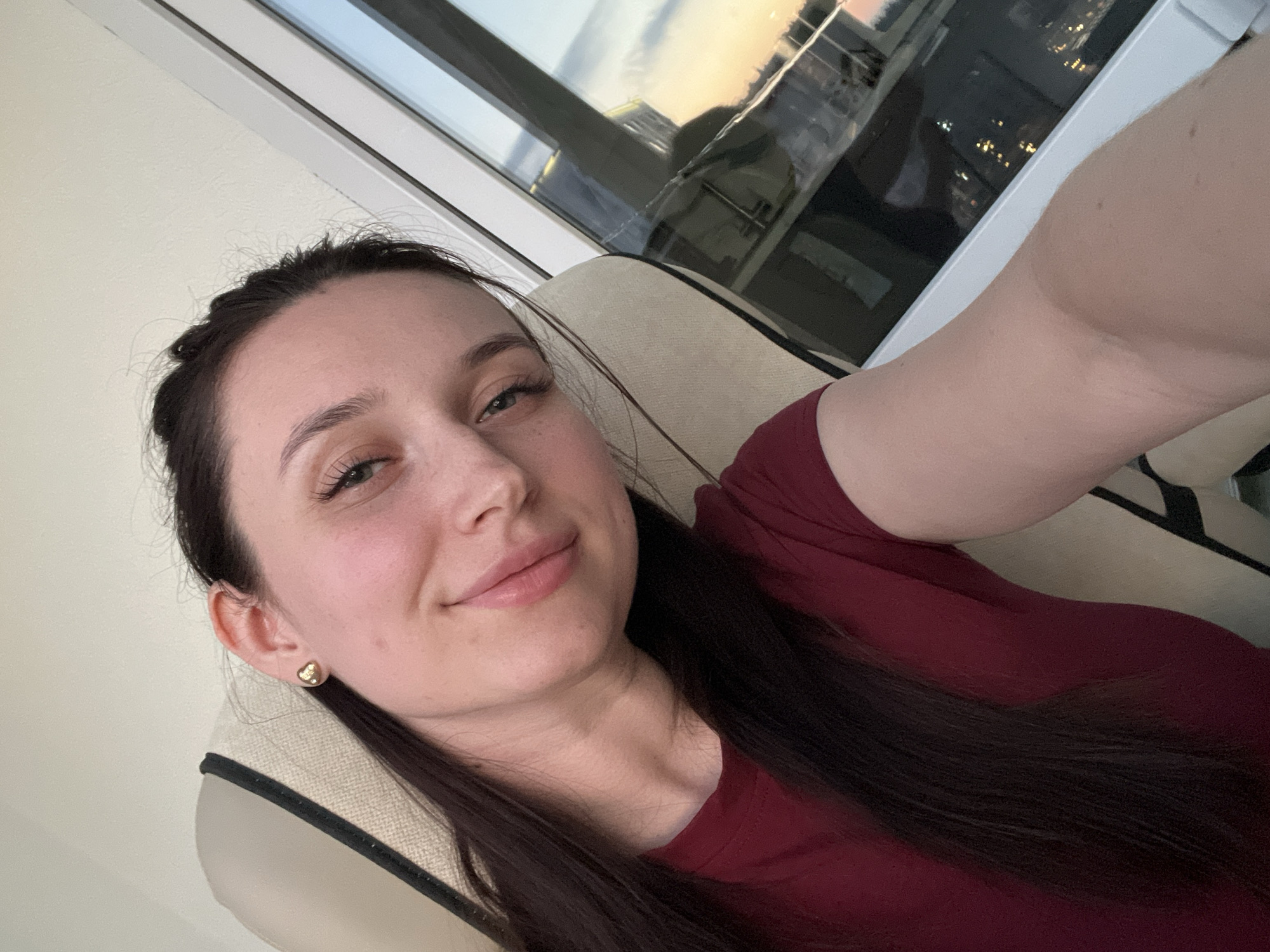 Woman takes selfies at dusk in Tyumen apartment
