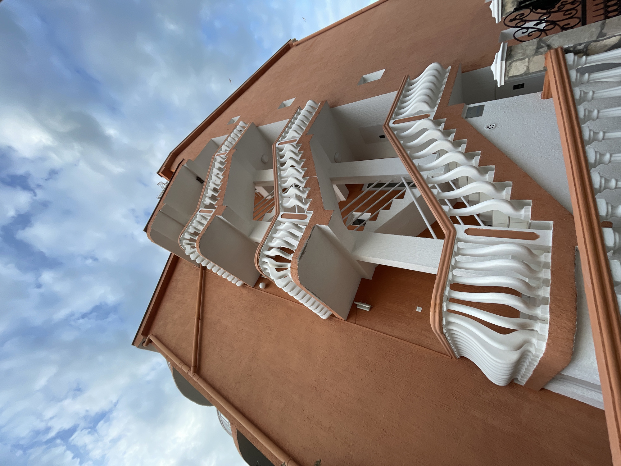 Orange building with white balconies photographed in Rafailovići