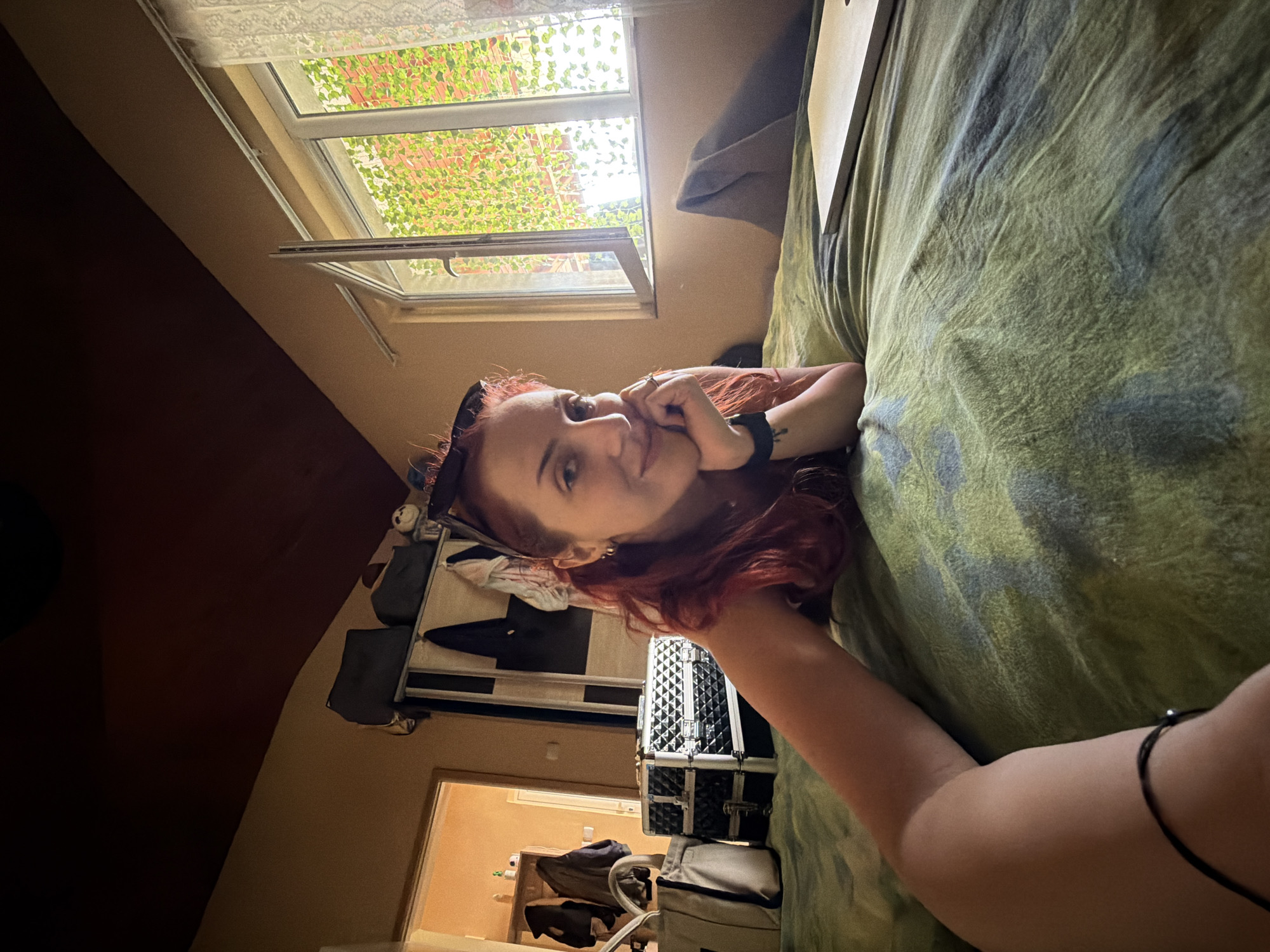Woman rests on patterned bed in Sofia apartment