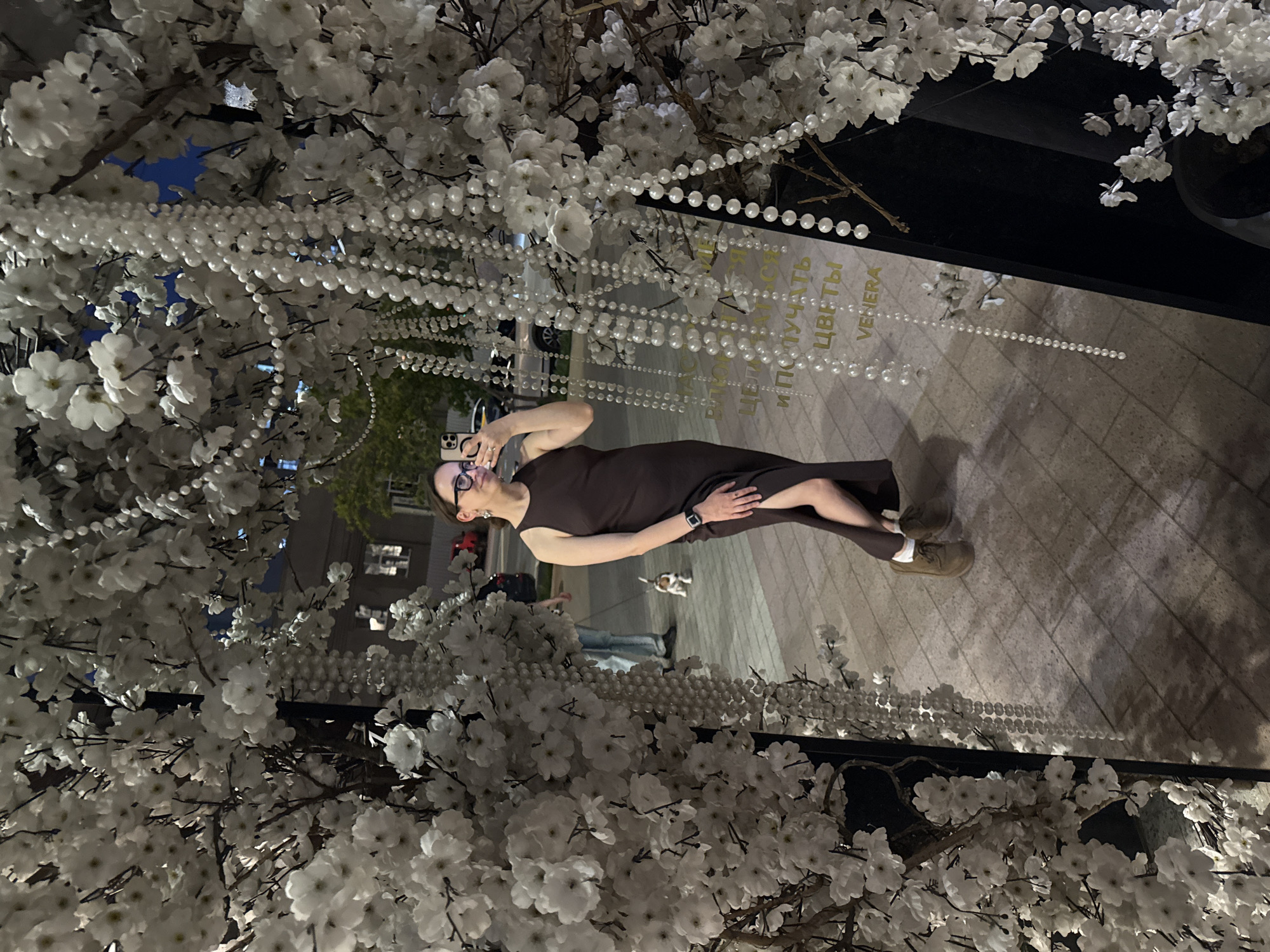 Woman photographed near decorated flower shop in Khimki, Russia