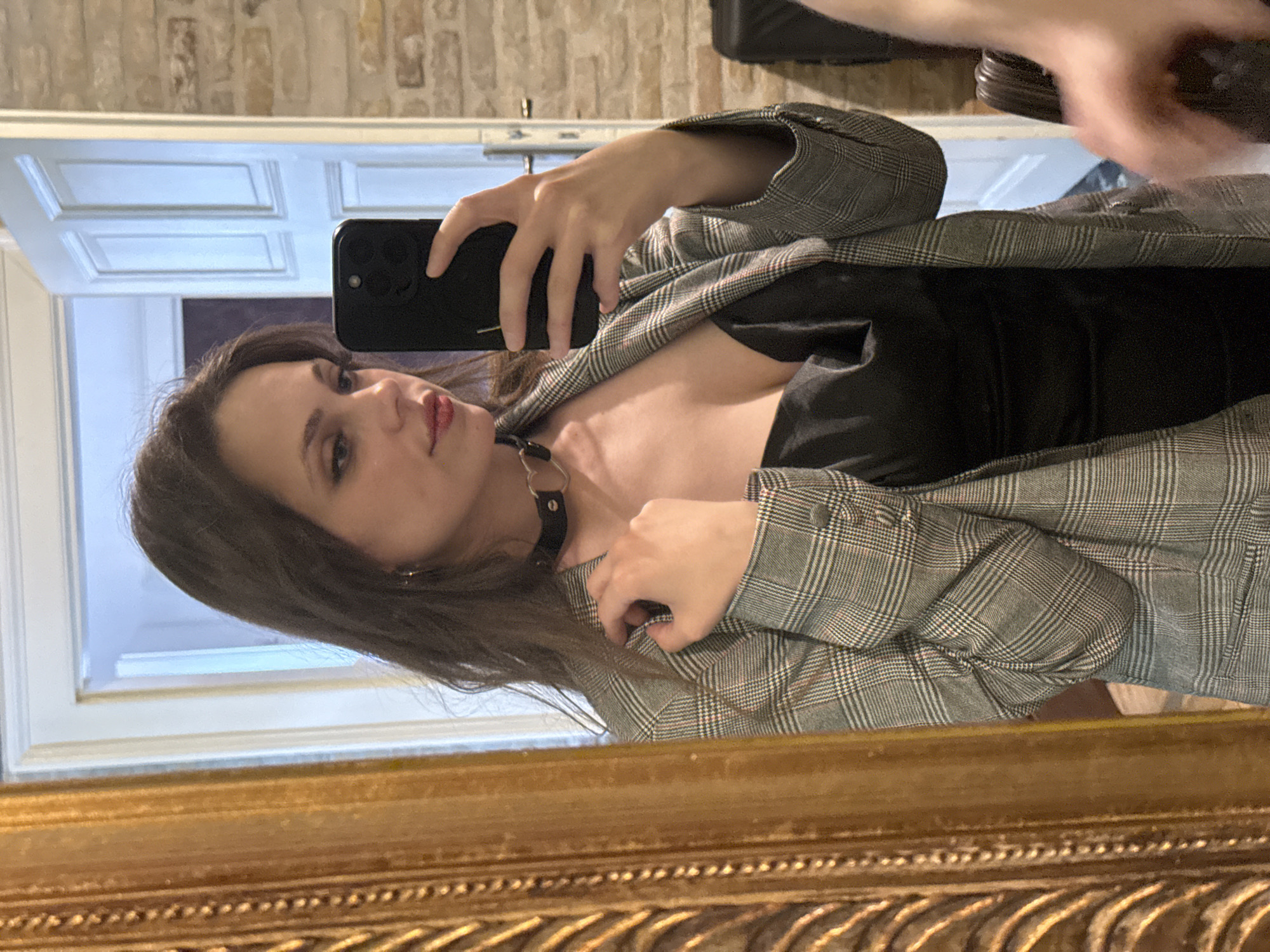 Woman takes mirror selfie in ornate frame, Budapest