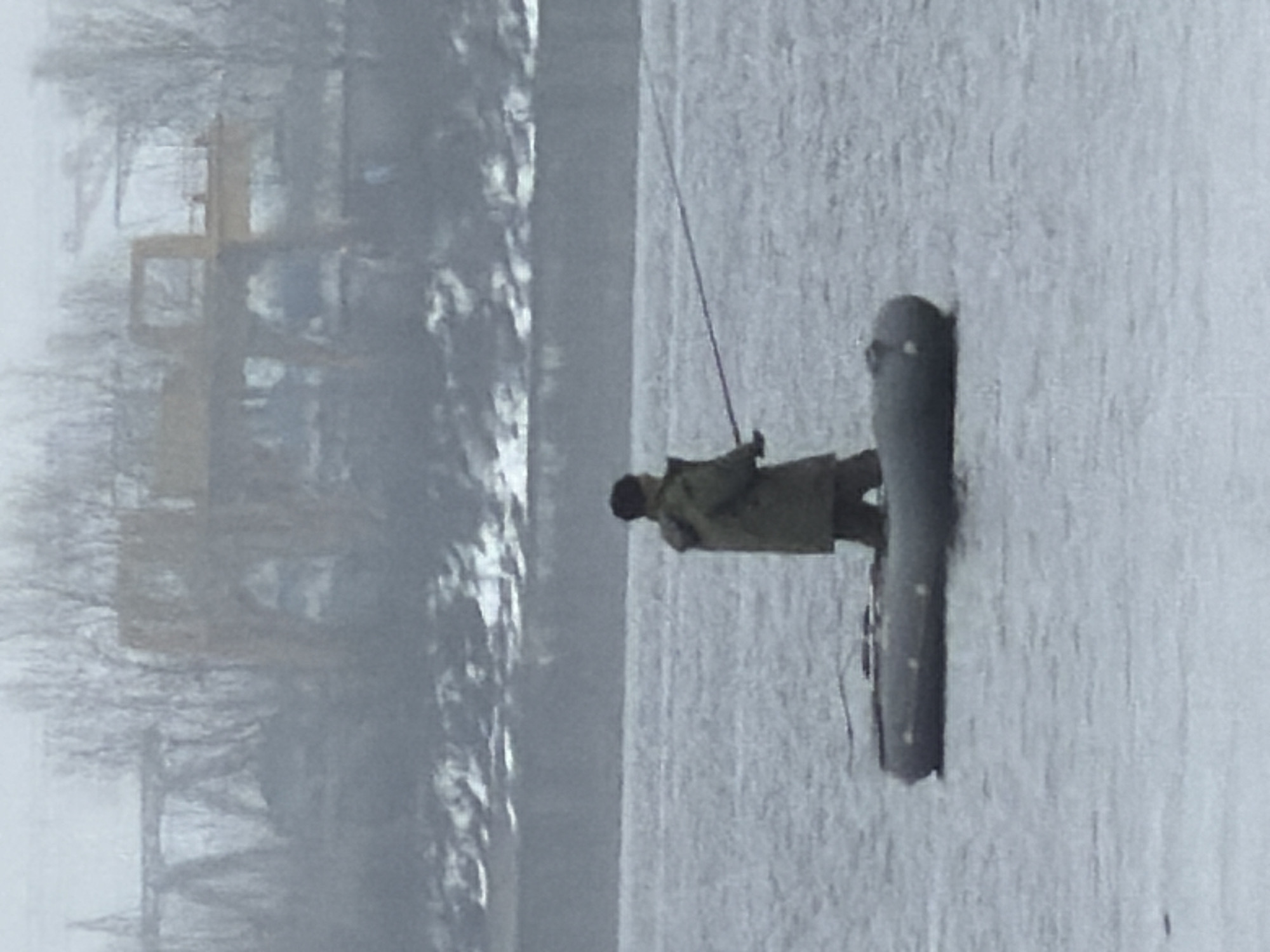 Ice fisherman catches small fish in Chaikovsky, Russia