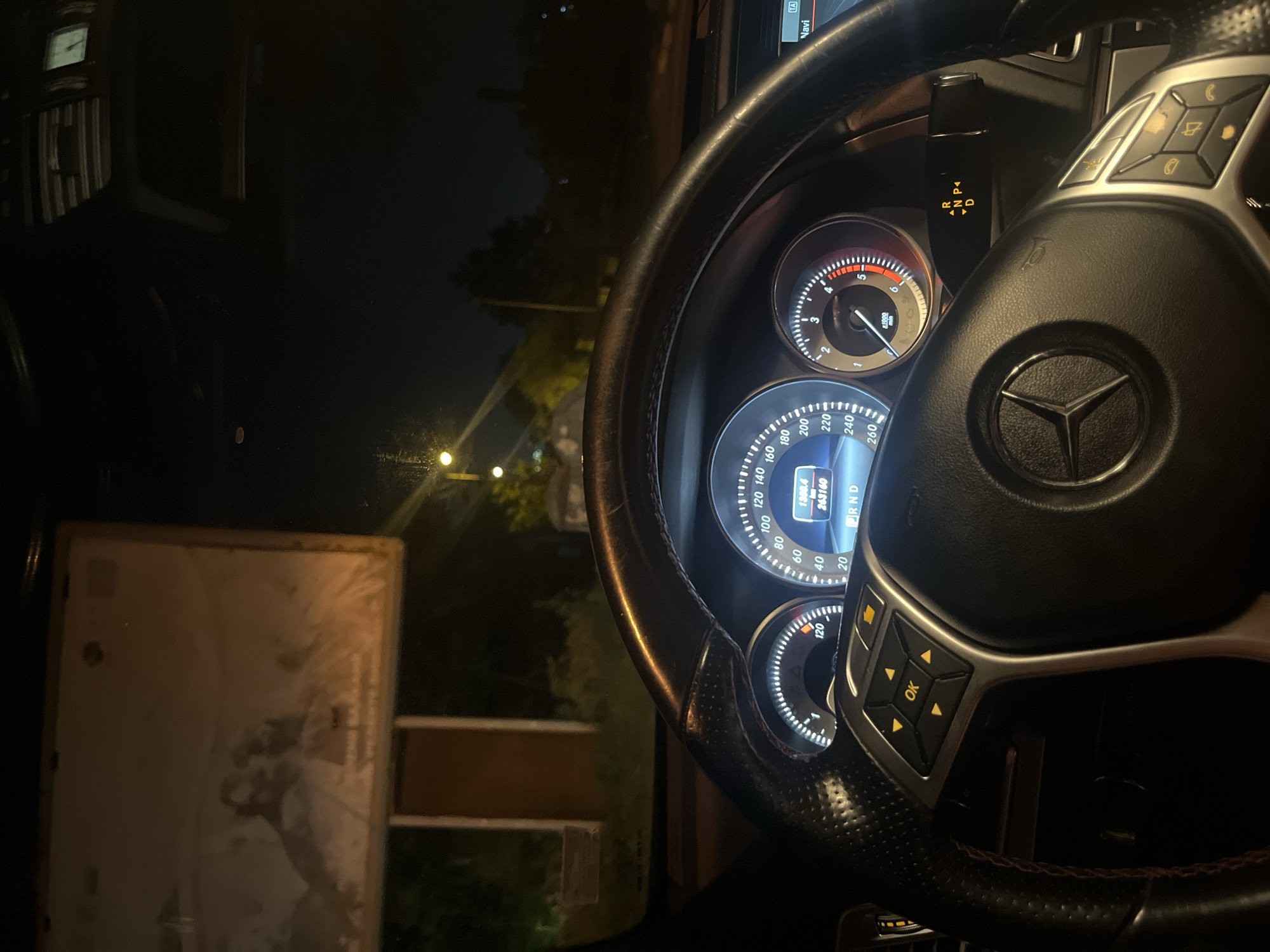 Mercedes-Benz spotted parked roadside at night with headlights on