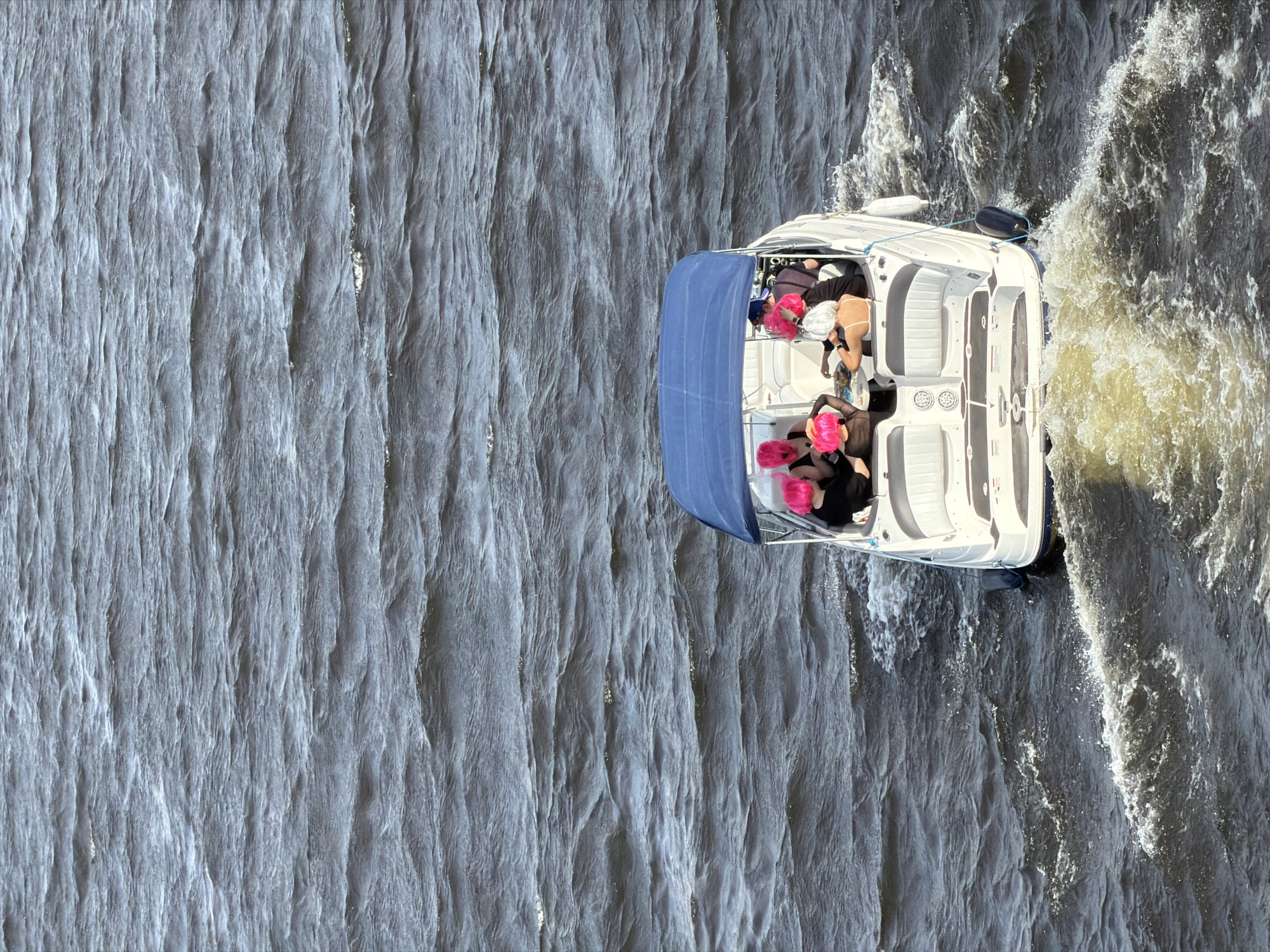 Motorboat navigates Neva River in Saint Petersburg during afternoon