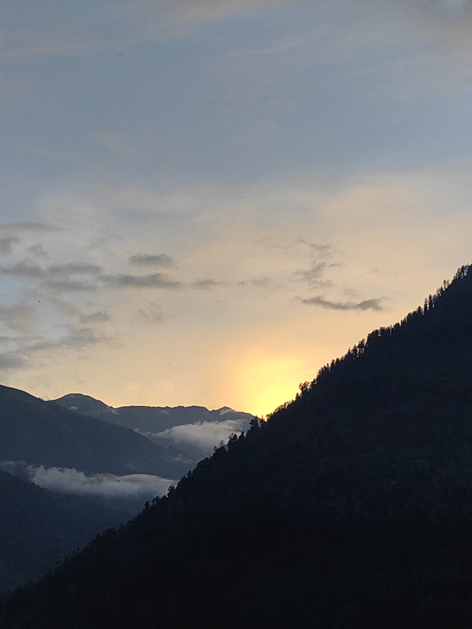 Golden hour over the forested mountains of Vashisht, India