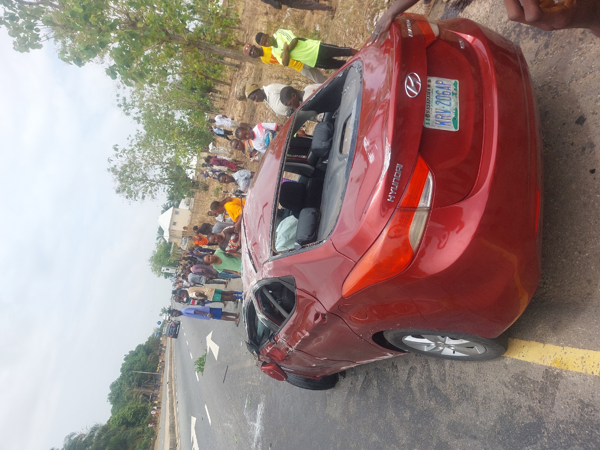 Severe car accident damages red sedan in Akwanga Nigeria