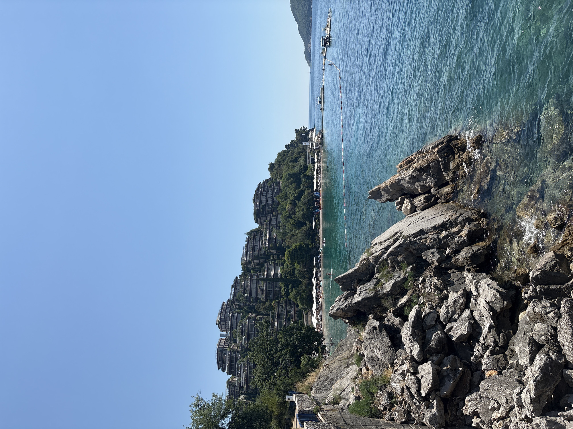 Budva's rocky coastline and resort hillsides on a clear summer morning