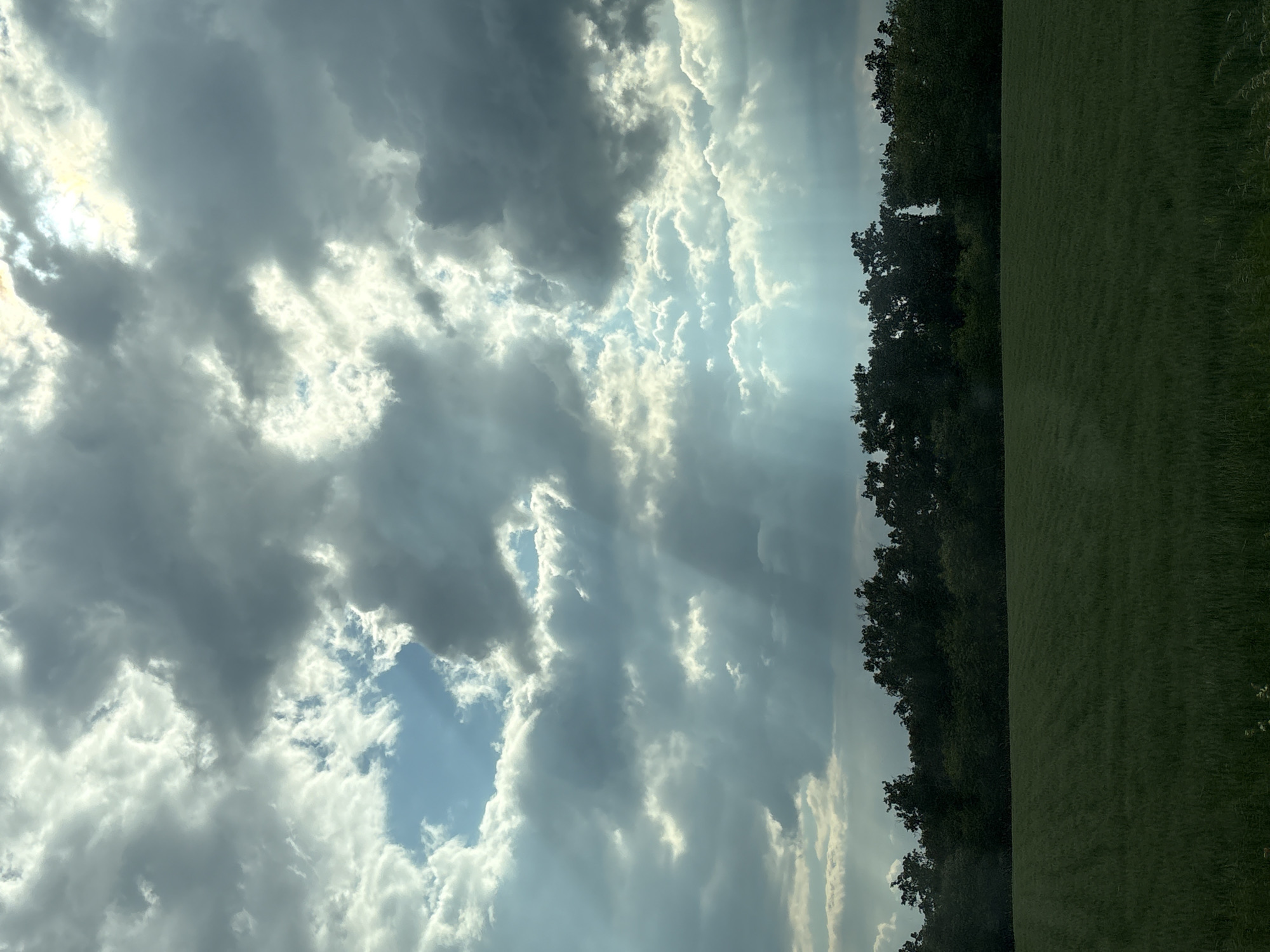 Dramatic sunbeams pierce clouds over Serbian countryside