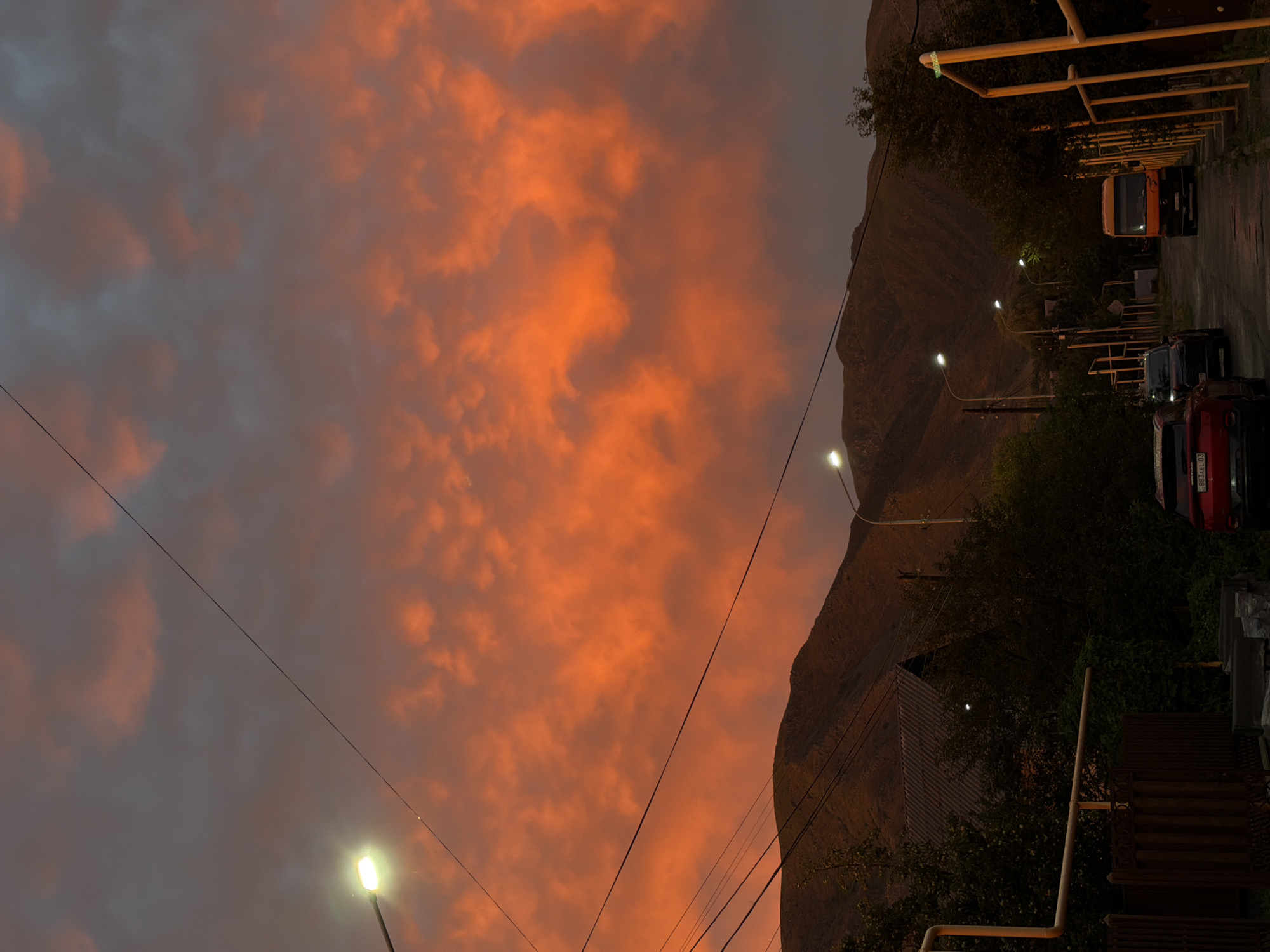 Fiery sunset sky over a quiet street in Tekeli, Kazakhstan