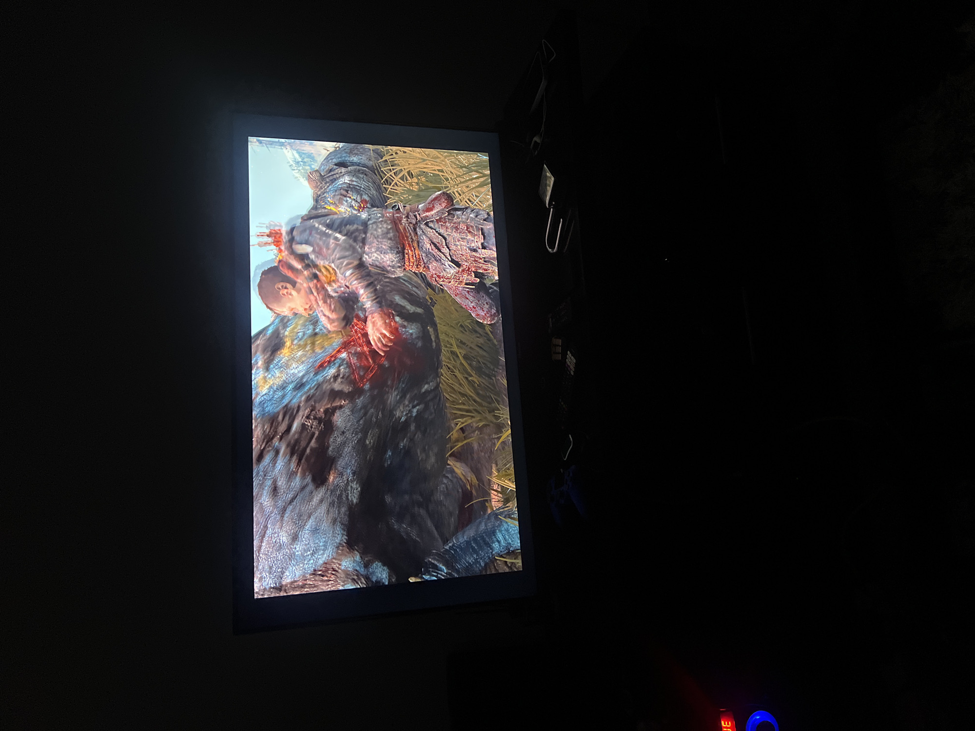 God of War Ragnarök gameplay and menus on a TV in Jos