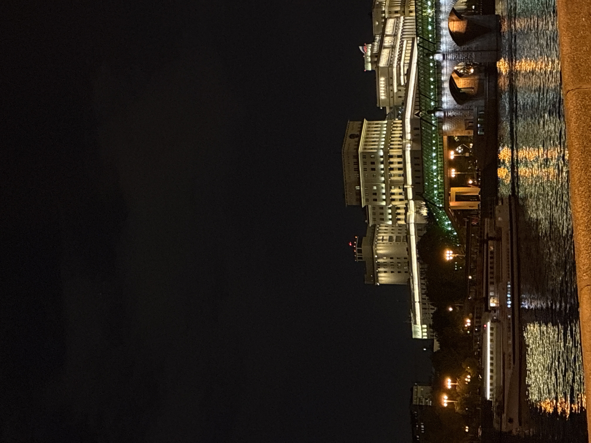 Moscow cityscape illuminated along Moskva River at night