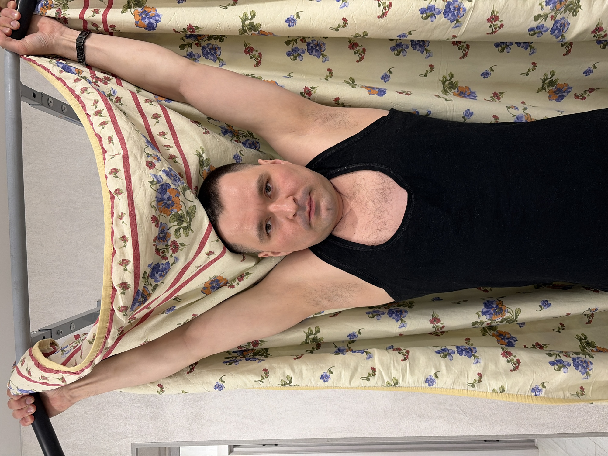 Man relaxes in bedroom with exercise equipment in Sarapul