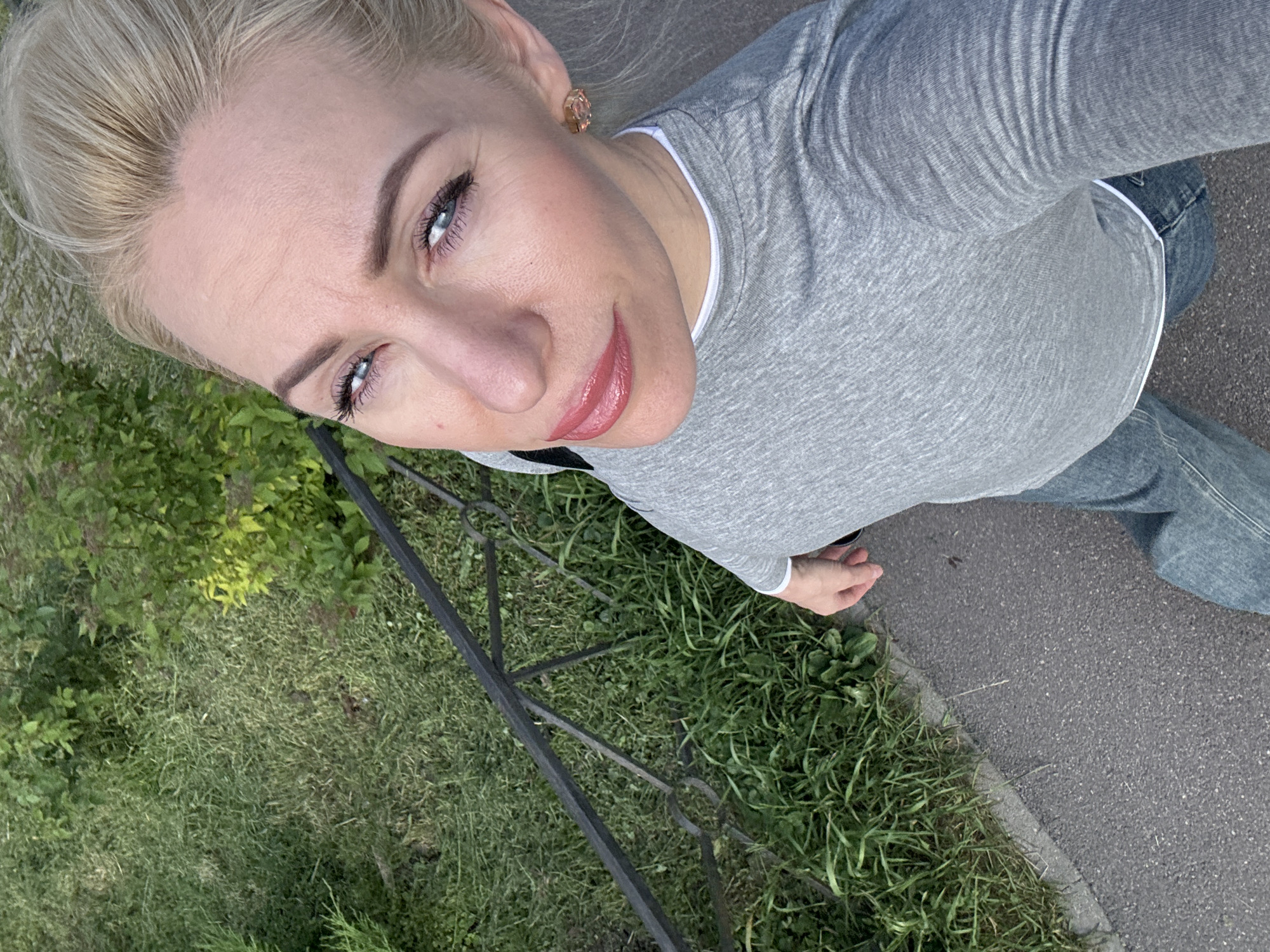 Woman takes outdoor selfies under cloudy sky