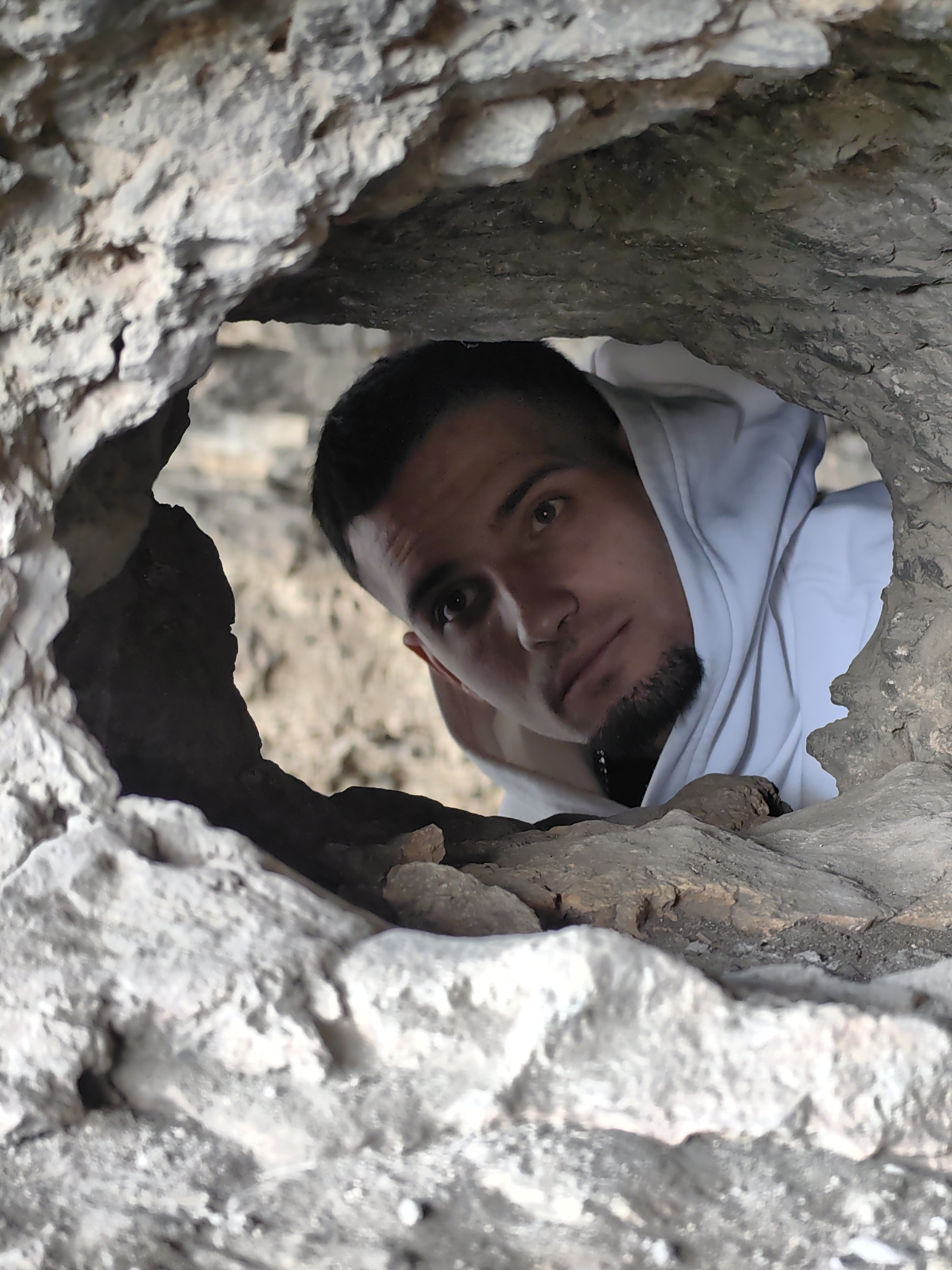 Young man explores rock formation near Marash, Bulgaria