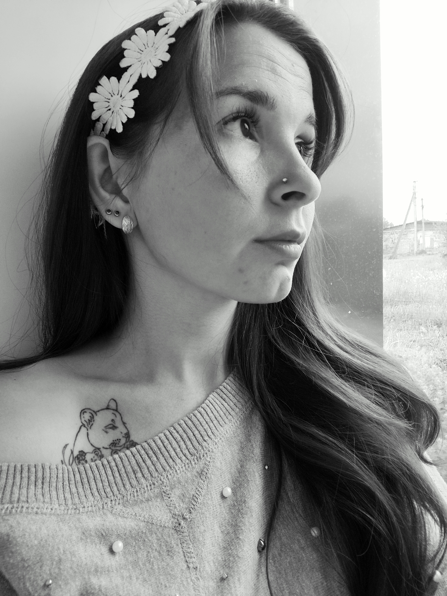 Woman with flower headband spotted at window in Фоки