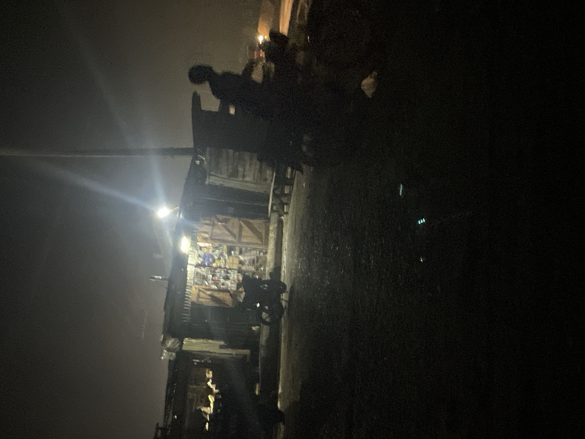 Night traffic and roadside activity along a Lokoja highway
