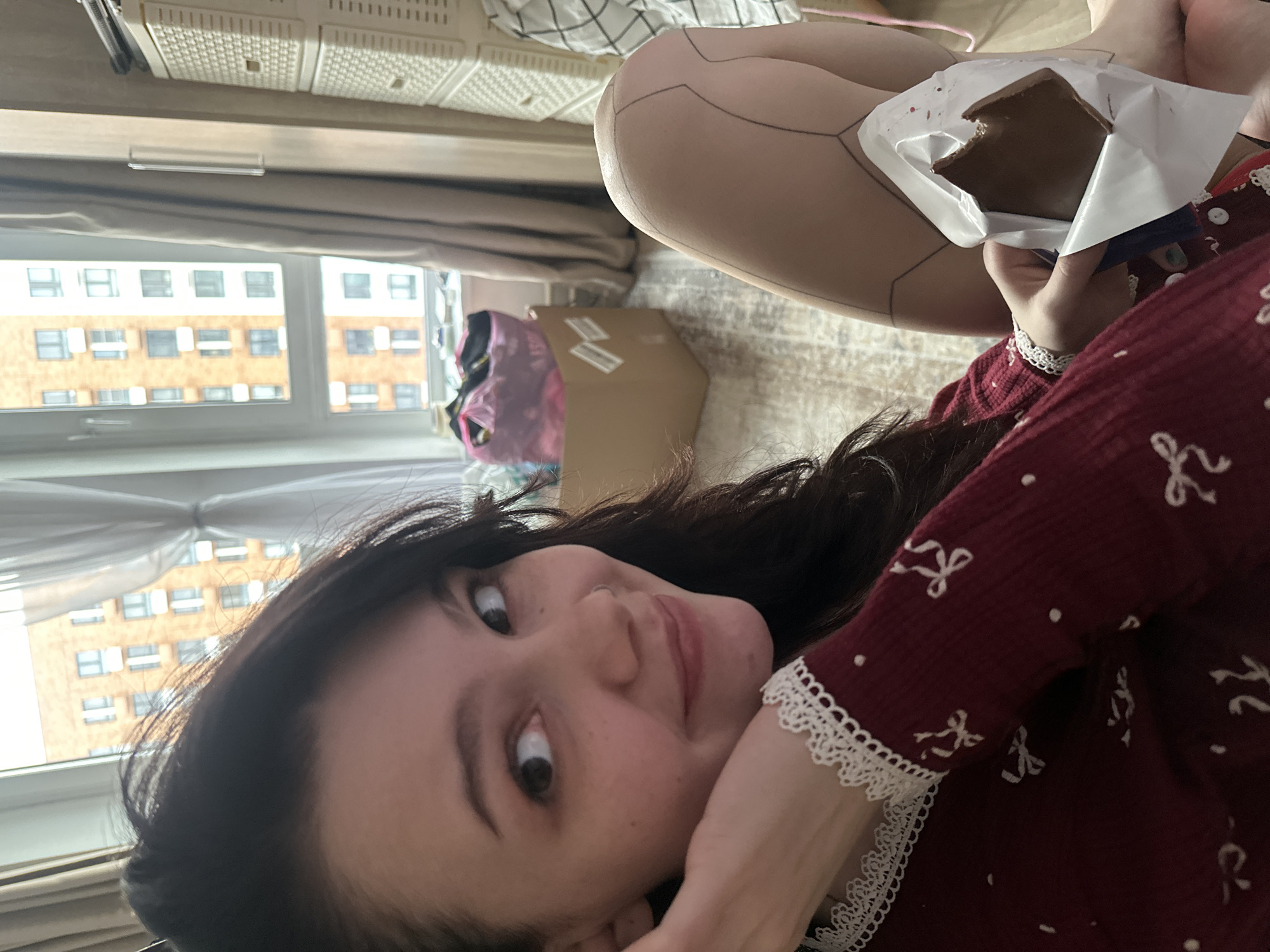Woman enjoys chocolate snack in Lyubertsy apartment