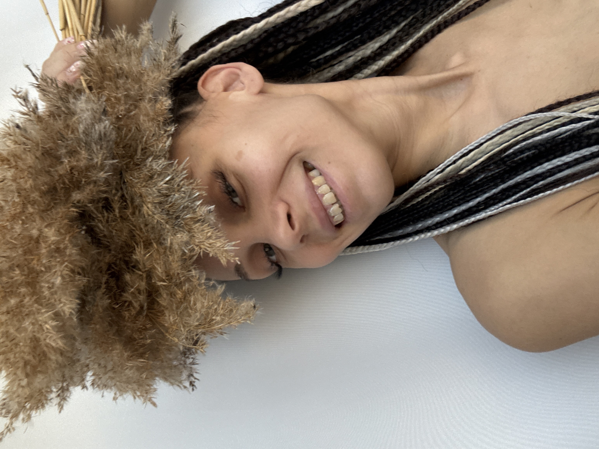 Woman photographed with dried plants in studio session