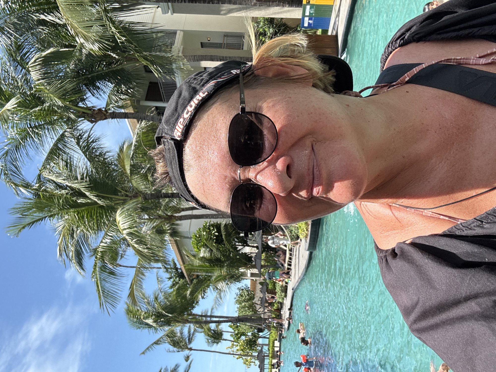 Woman takes poolside selfie at Thai resort