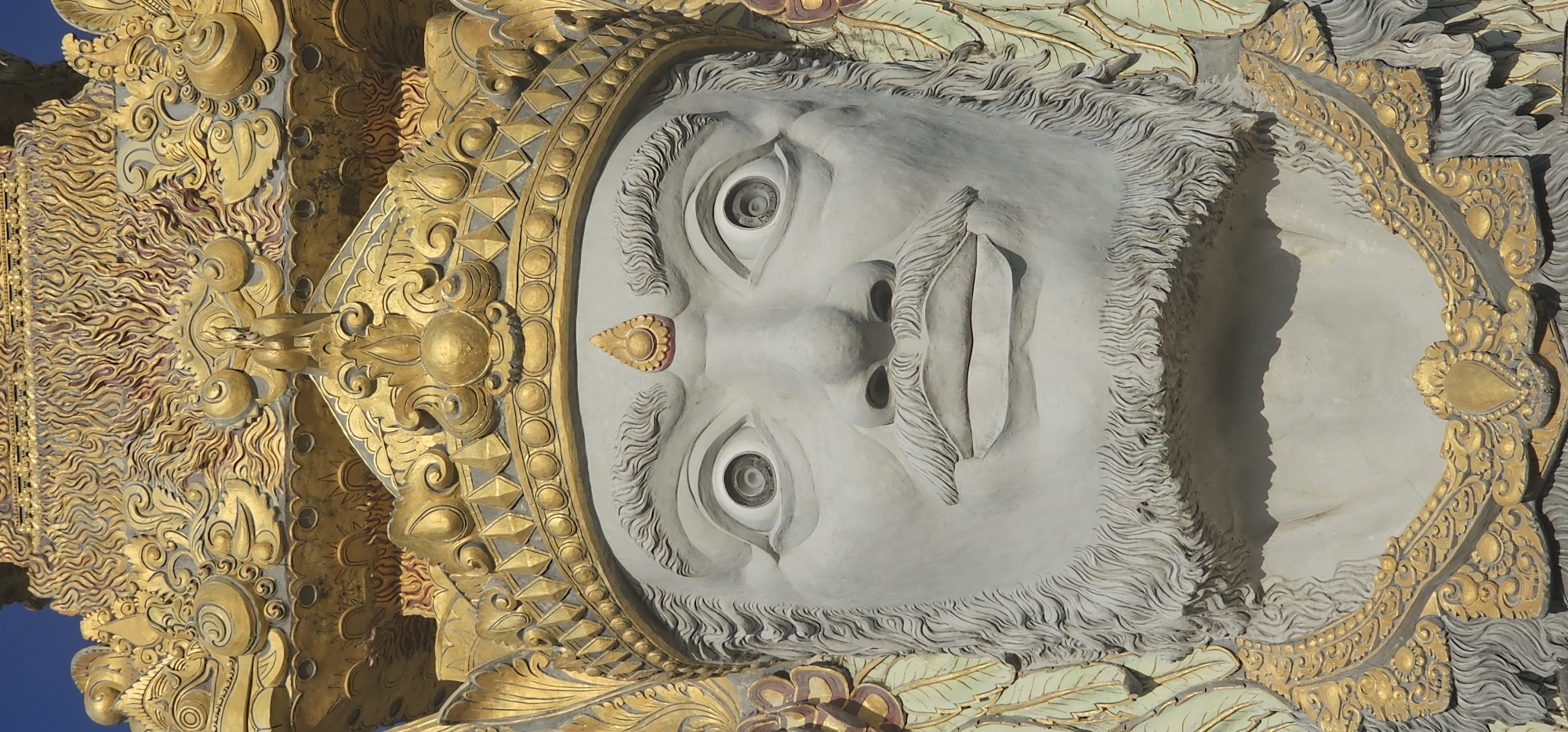 Multi-faced crowned statue monument documented in Denpasar, Indonesia