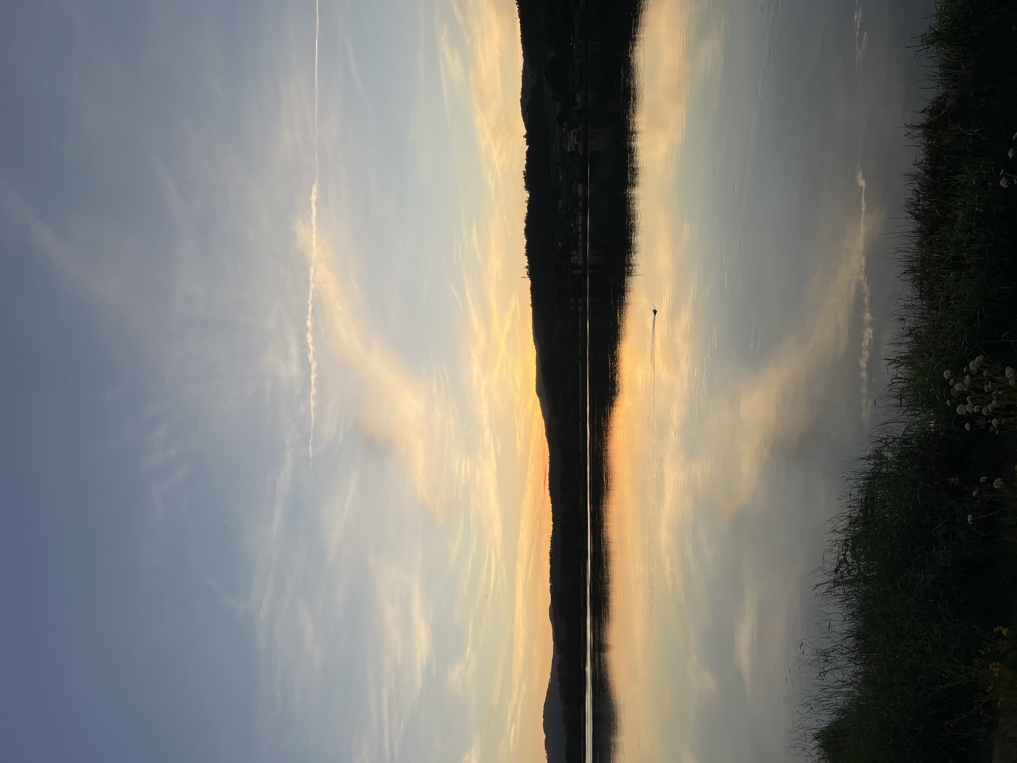 Couple enjoys evening lakeside picnic in Gondarém, Portugal