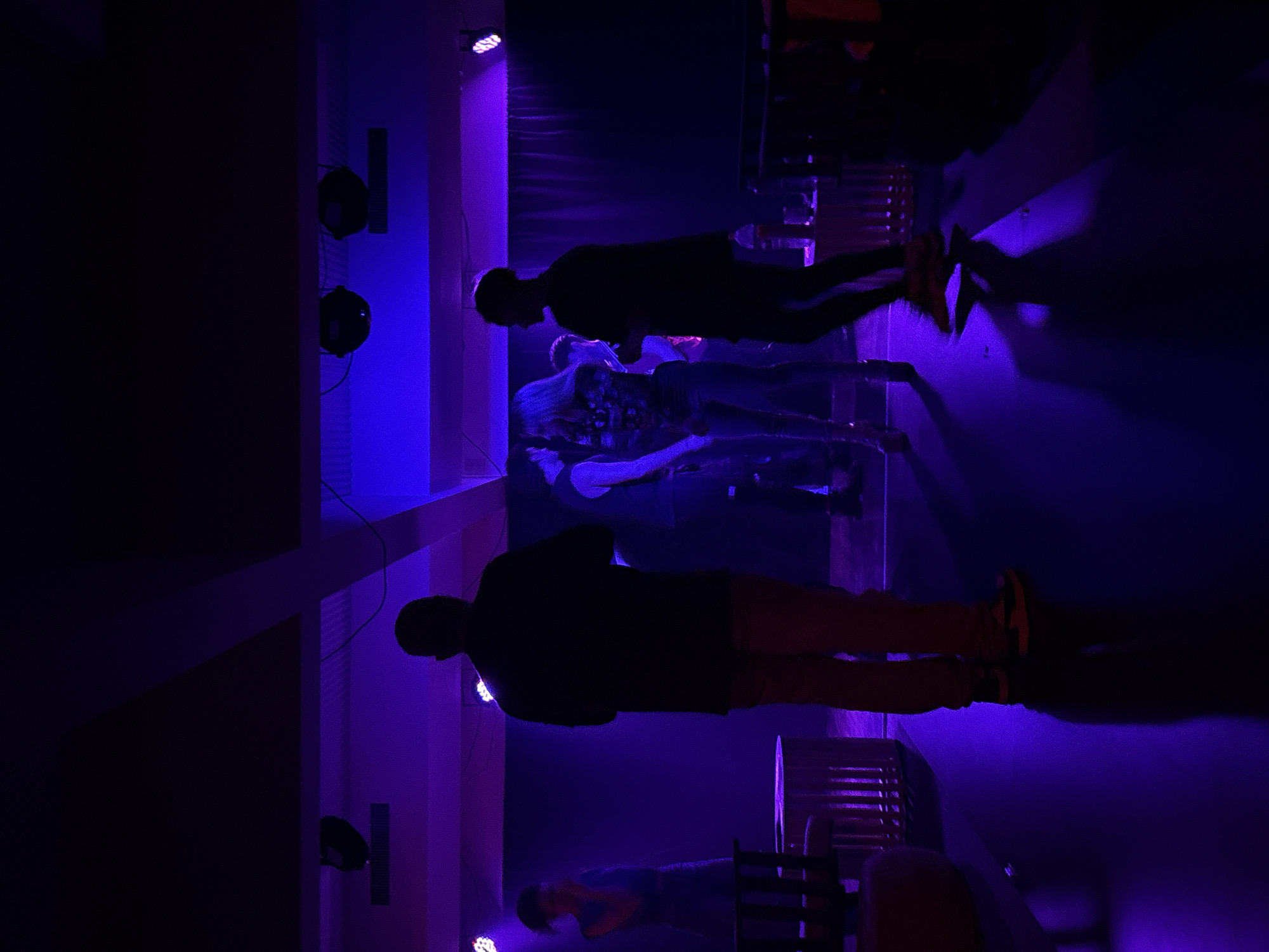 Late-night Buenos Aires event with dramatic stage lighting and a standout white gown