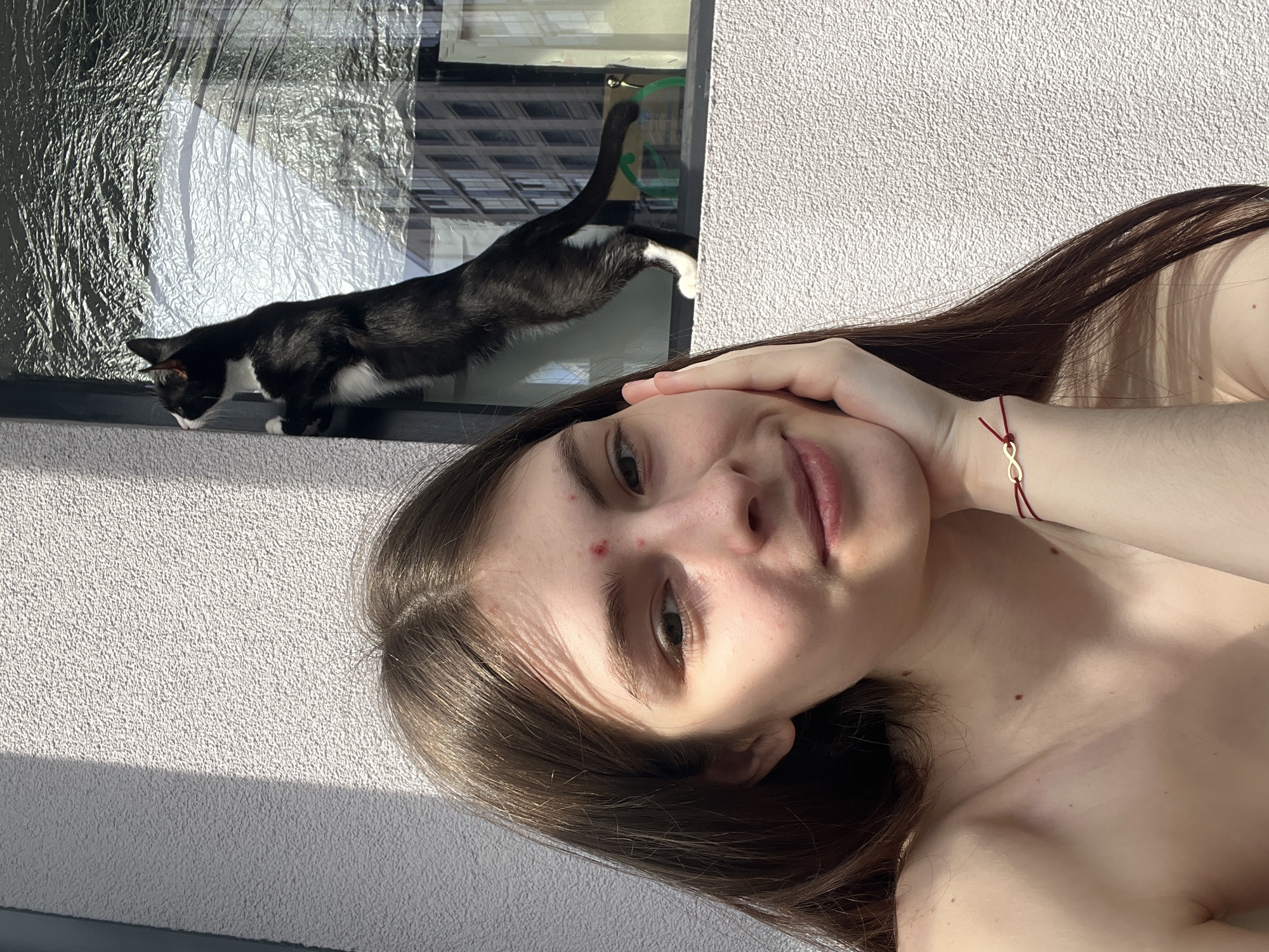 Woman takes selfies with black and white cat in Saint Petersburg