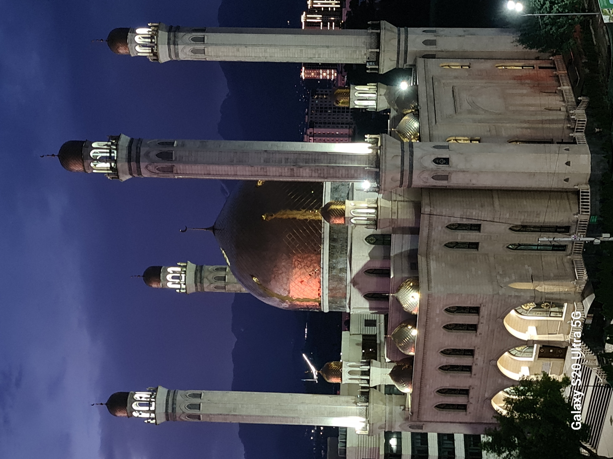 Almaty's Central Mosque glows at dusk under a vivid twilight sky