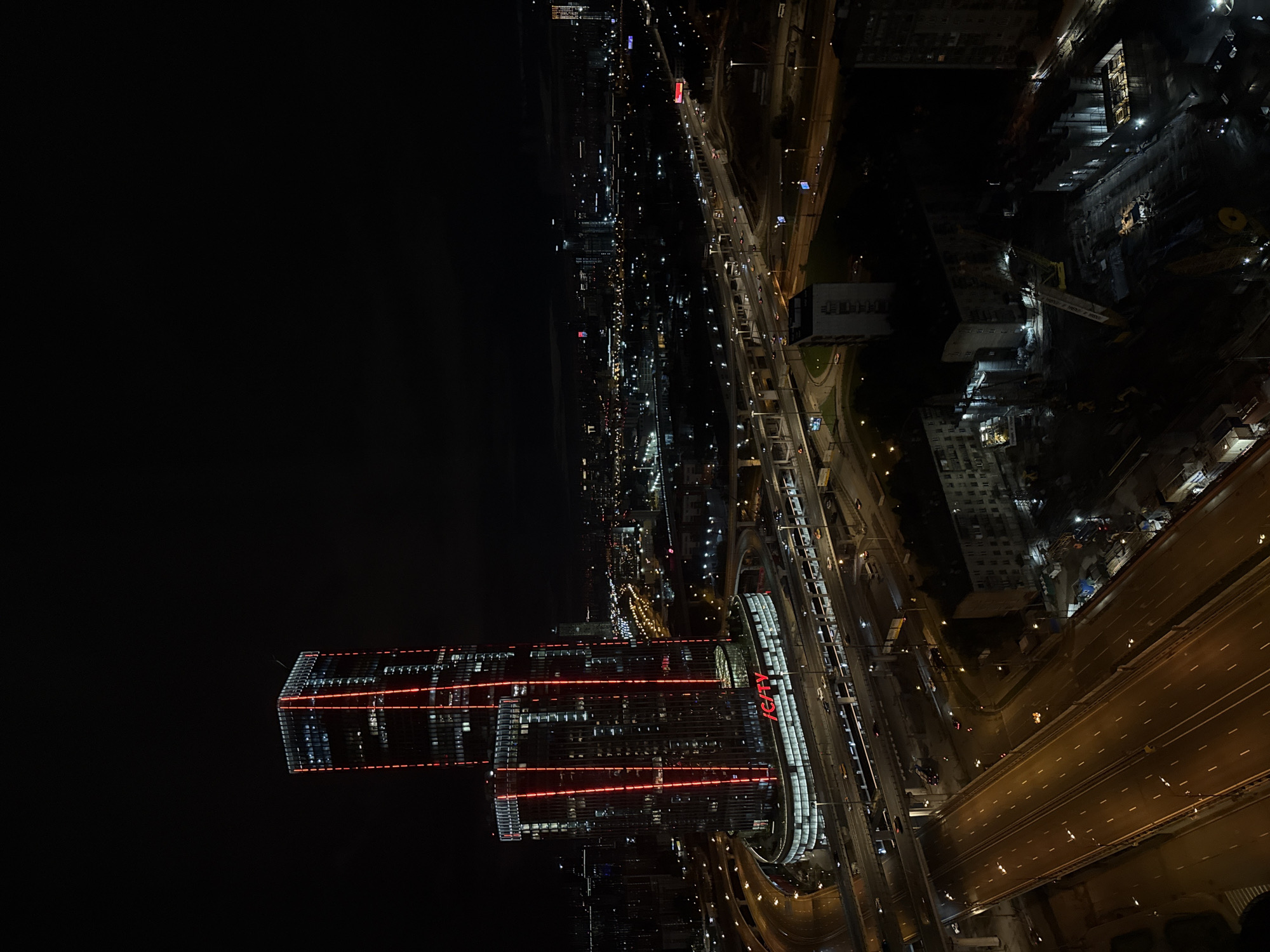 Aerial nighttime views of a city skyline anchored by ICITY towers