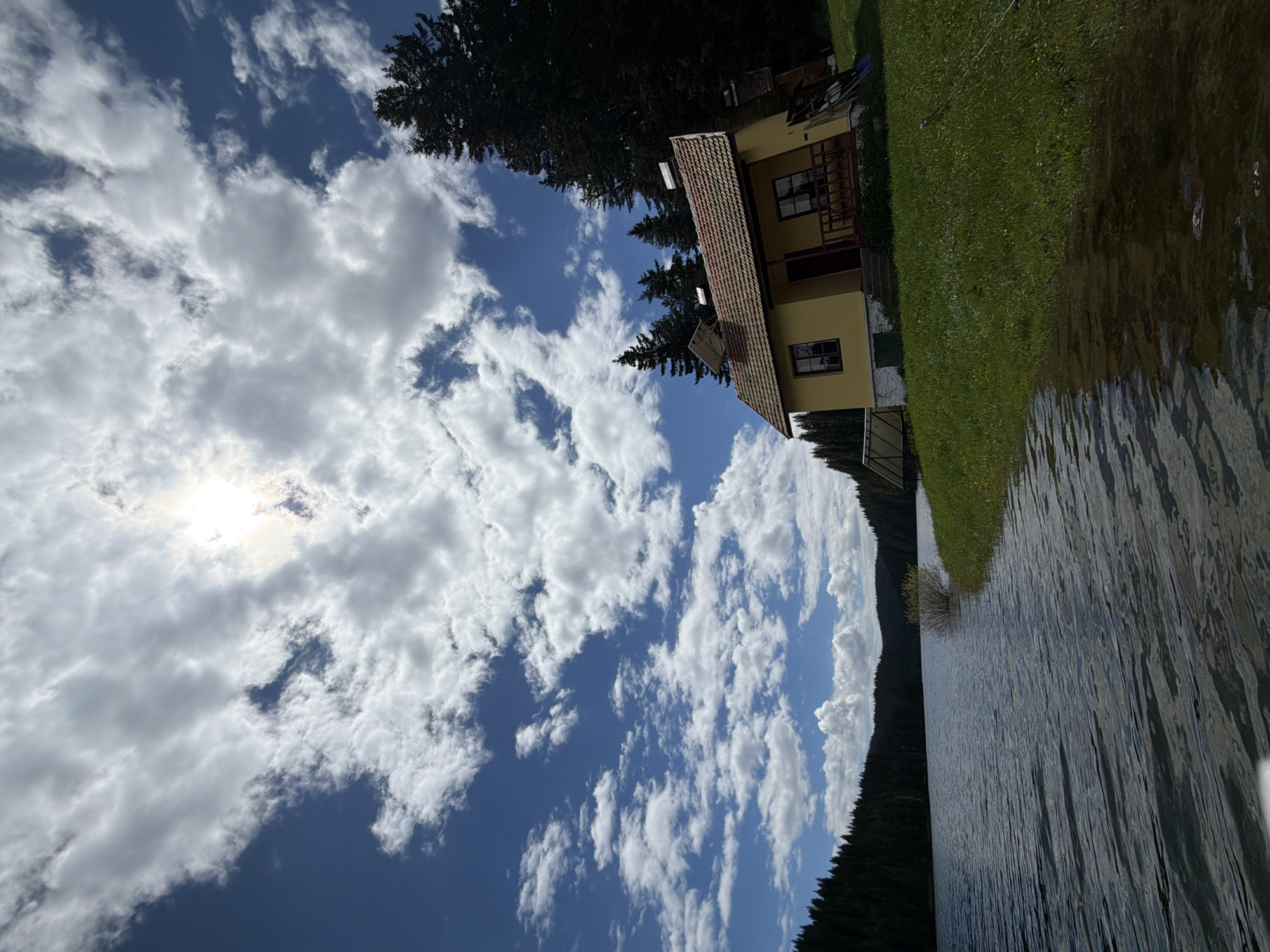 Lakeside community with yellow house and wooden amenities documented