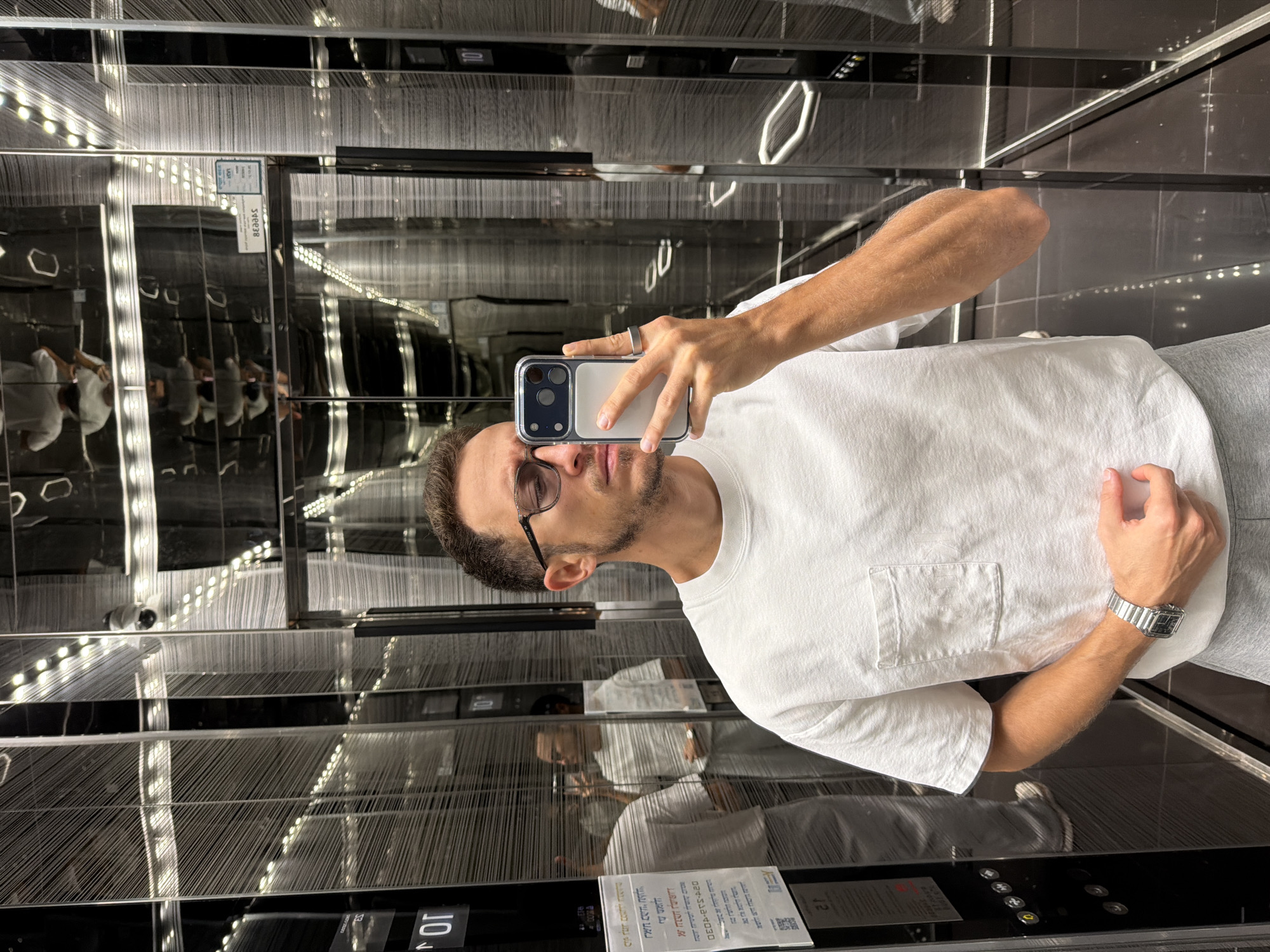 Man Takes Selfie in Mirrored Elevator