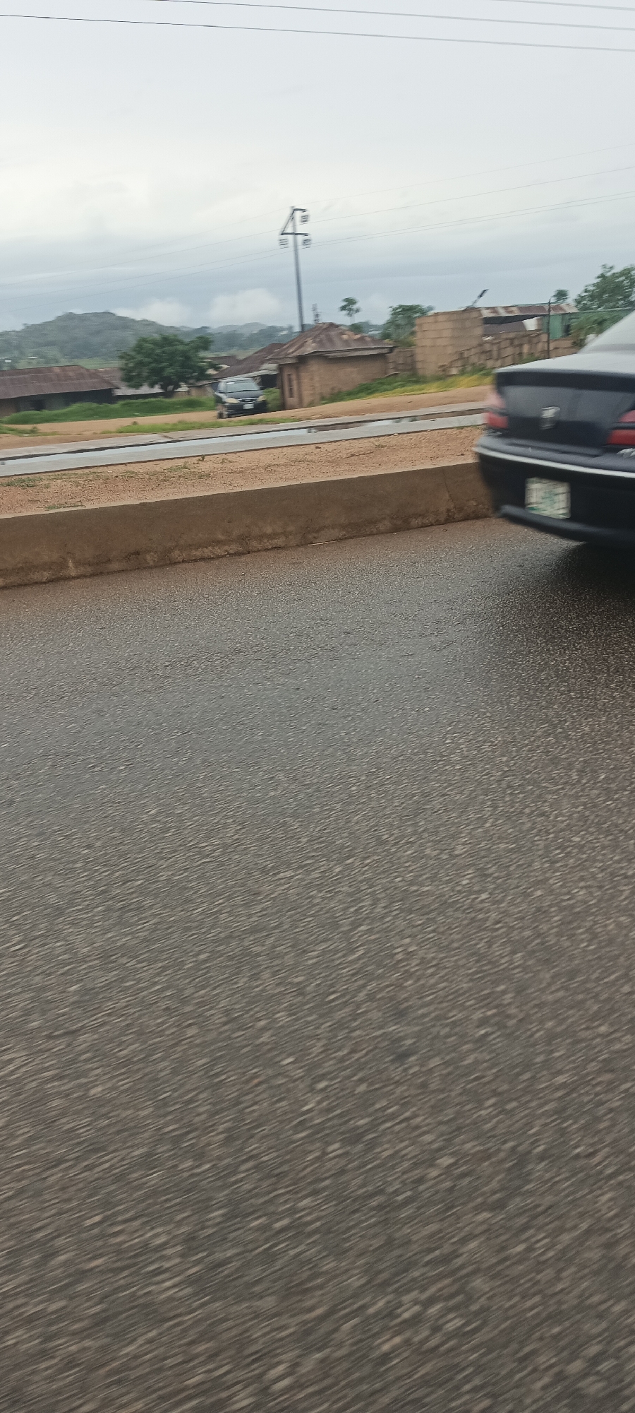 Overcast street scenes documented in Bukuru, Nigeria during morning commute