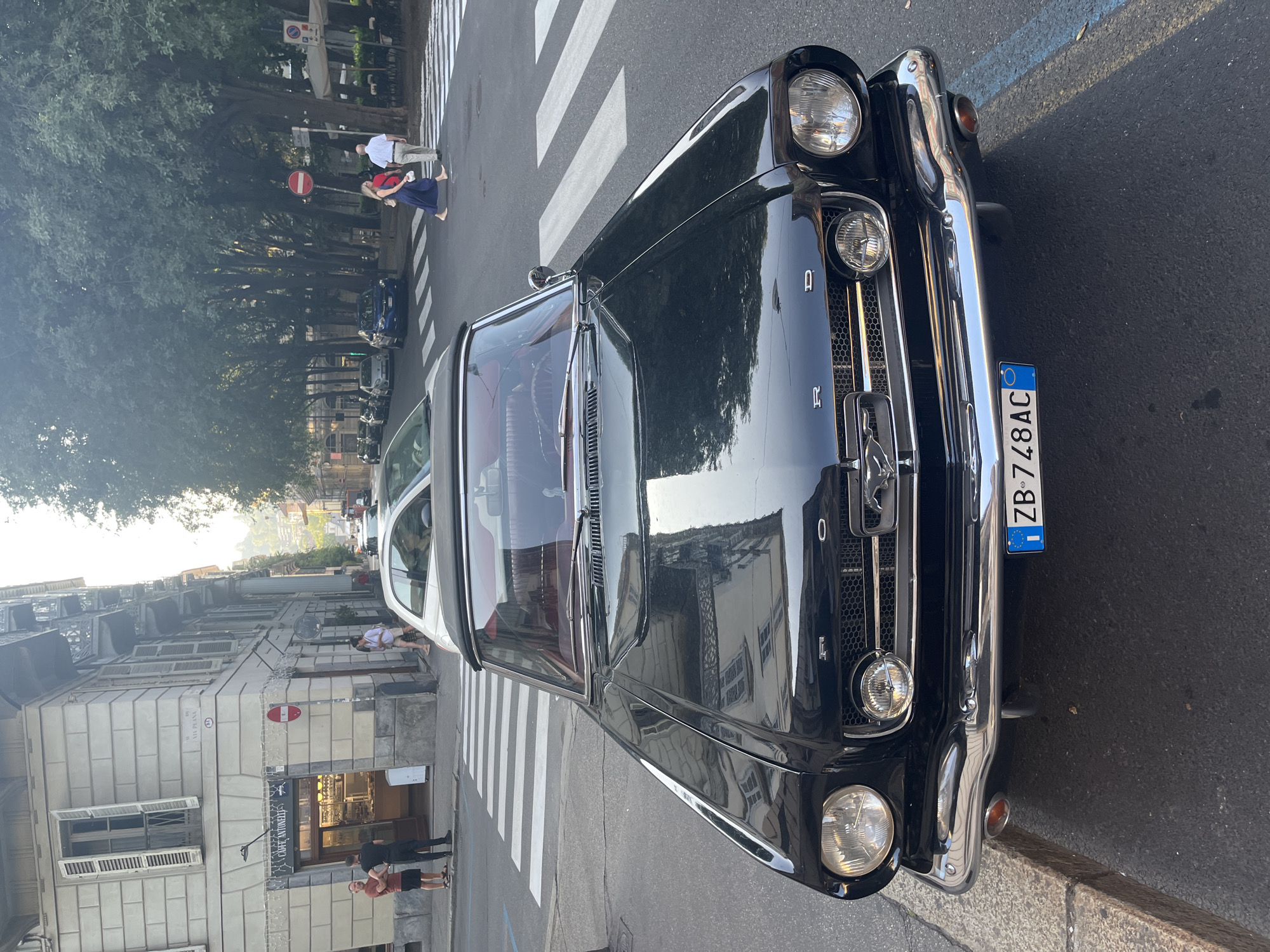 Classic black Mustang convertible parked on a Turin street
