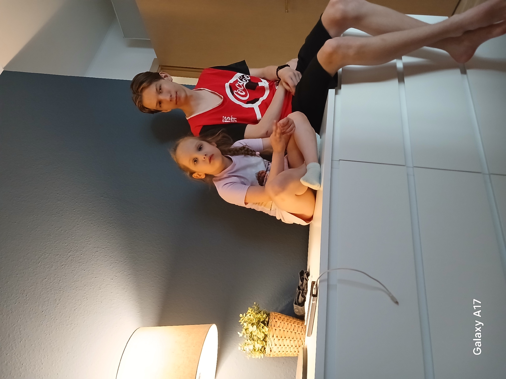 Siblings play together in Yekaterinburg home during afternoon