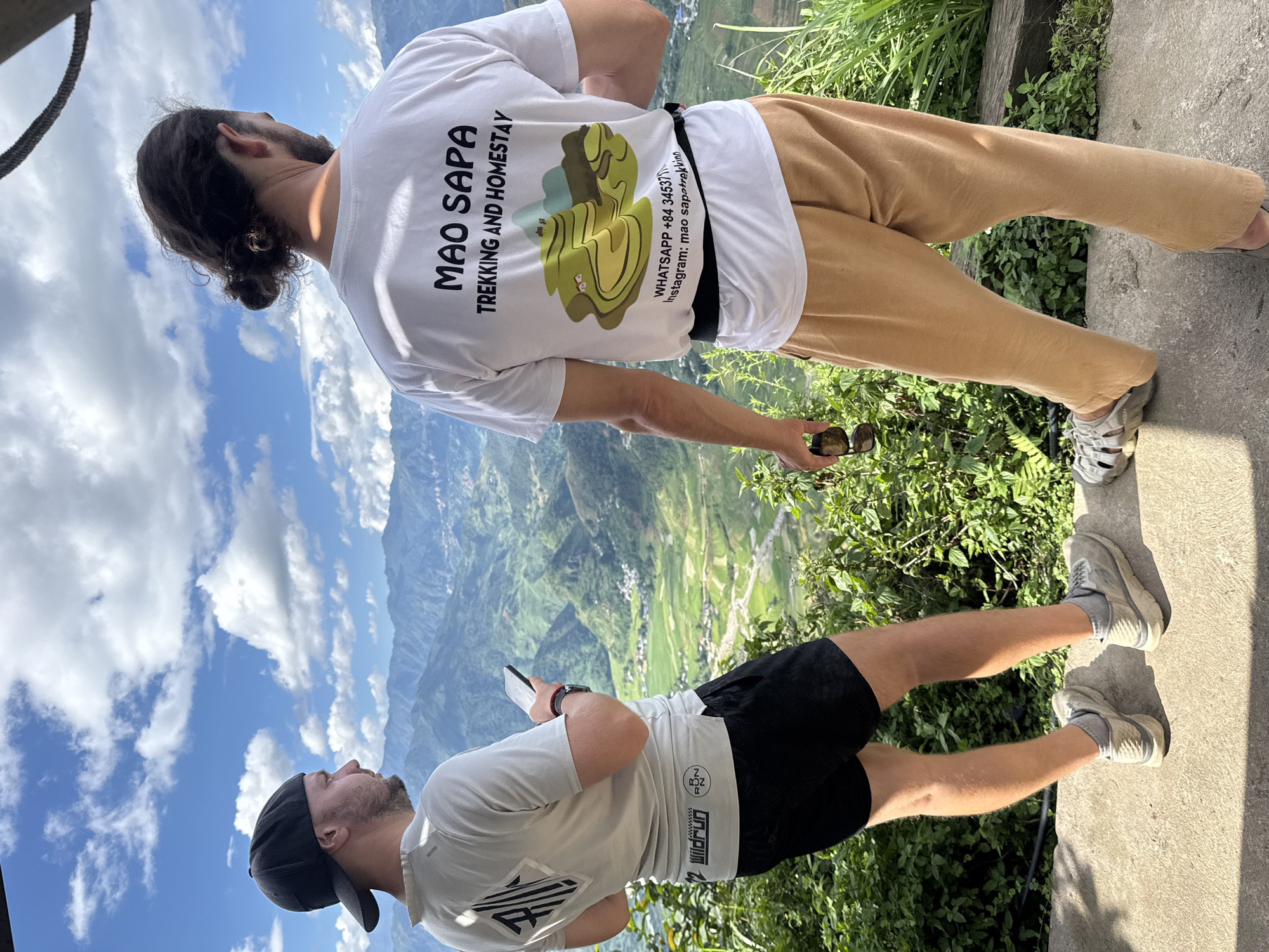 Tourists photograph scenic mountain views at Tu Le Vietnam overlooks