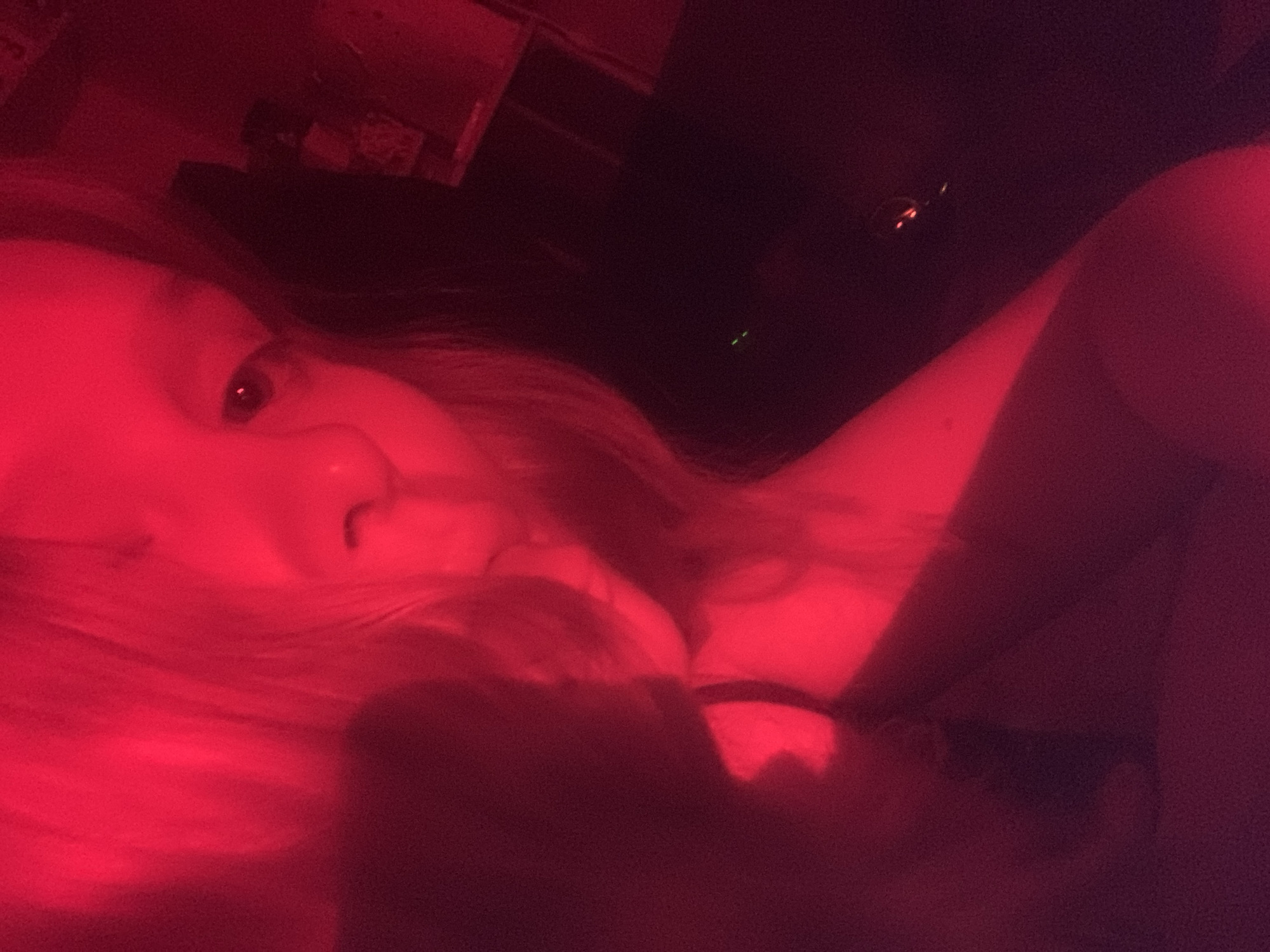Red-lit portraits and prop sword documented in Russian suburb