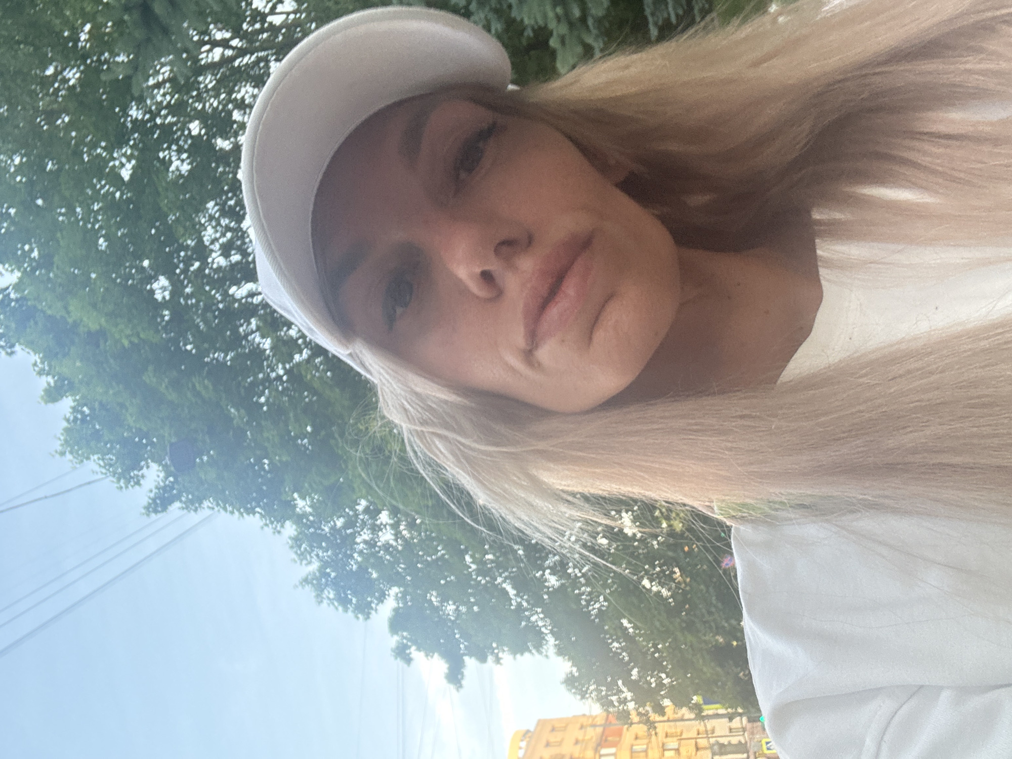 Woman photographs sunset stroll with French Bulldog in Saint Petersburg