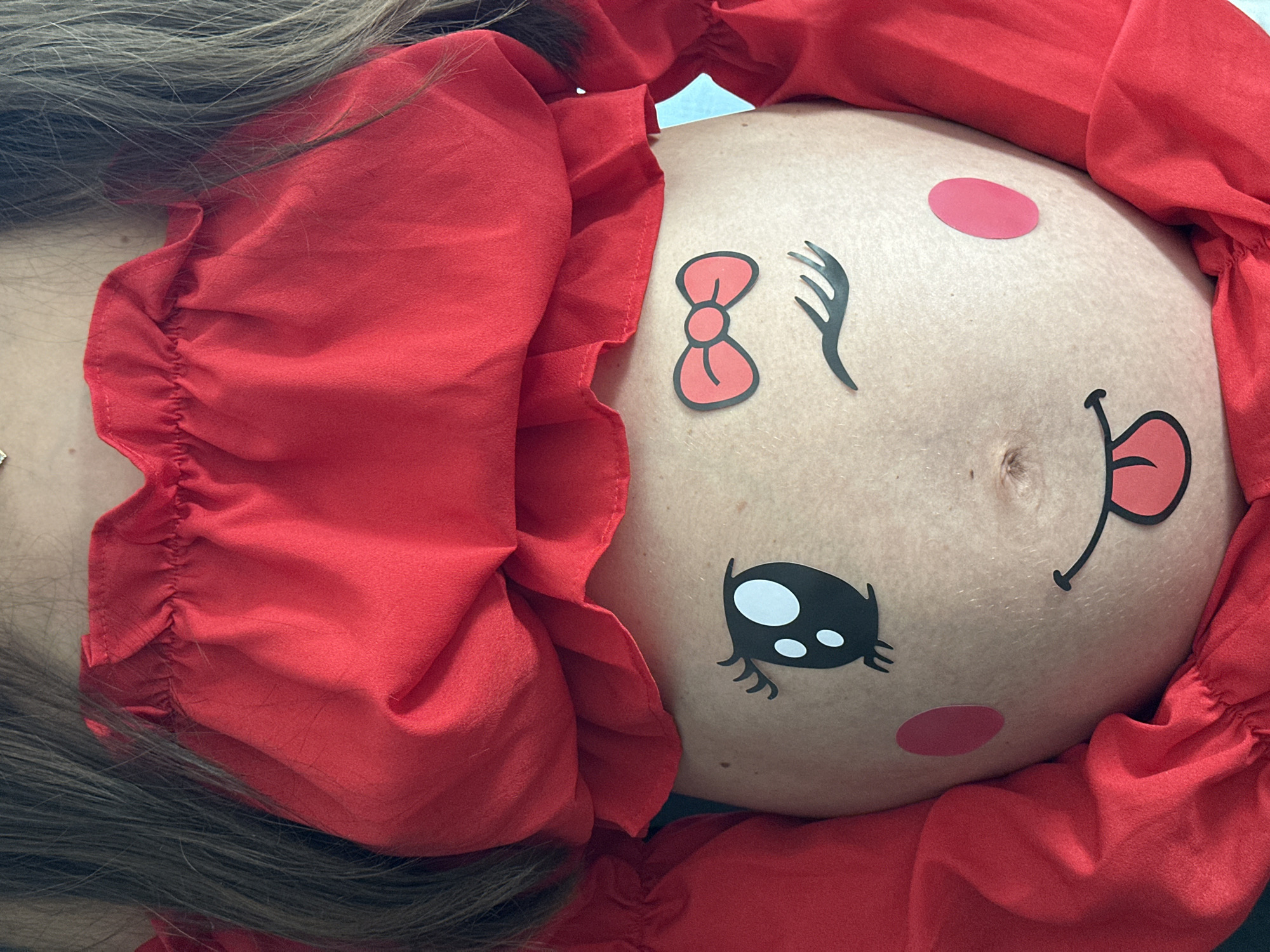 Pregnant woman celebrates with belly art and chocolate in Wisła