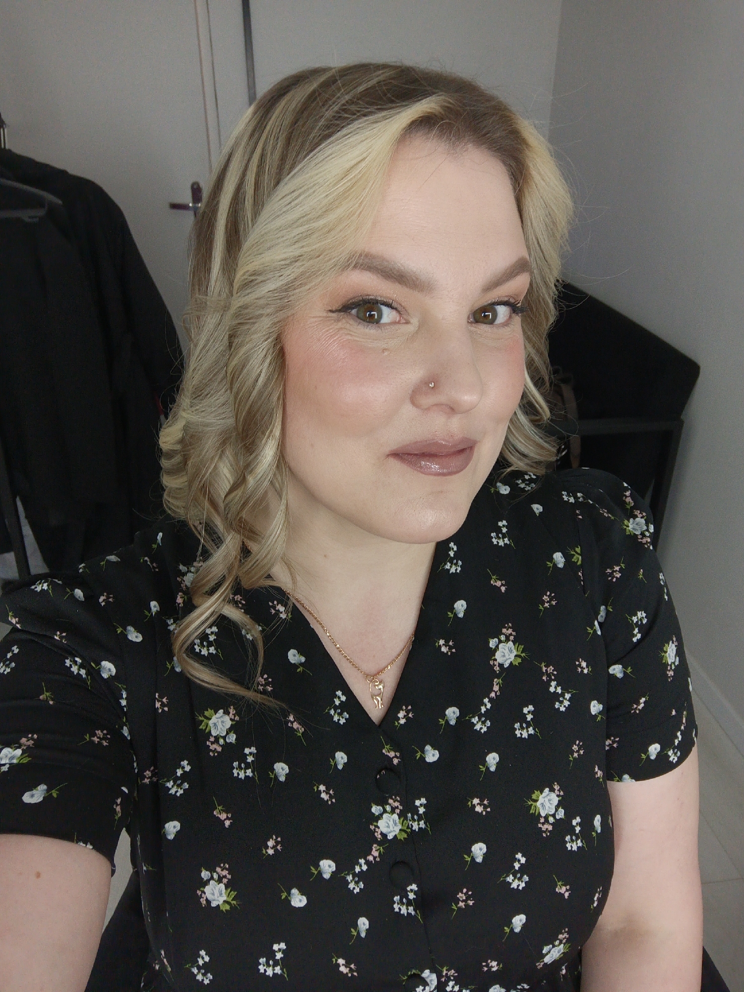 Woman poses for portrait photos in blonde hair, makeup