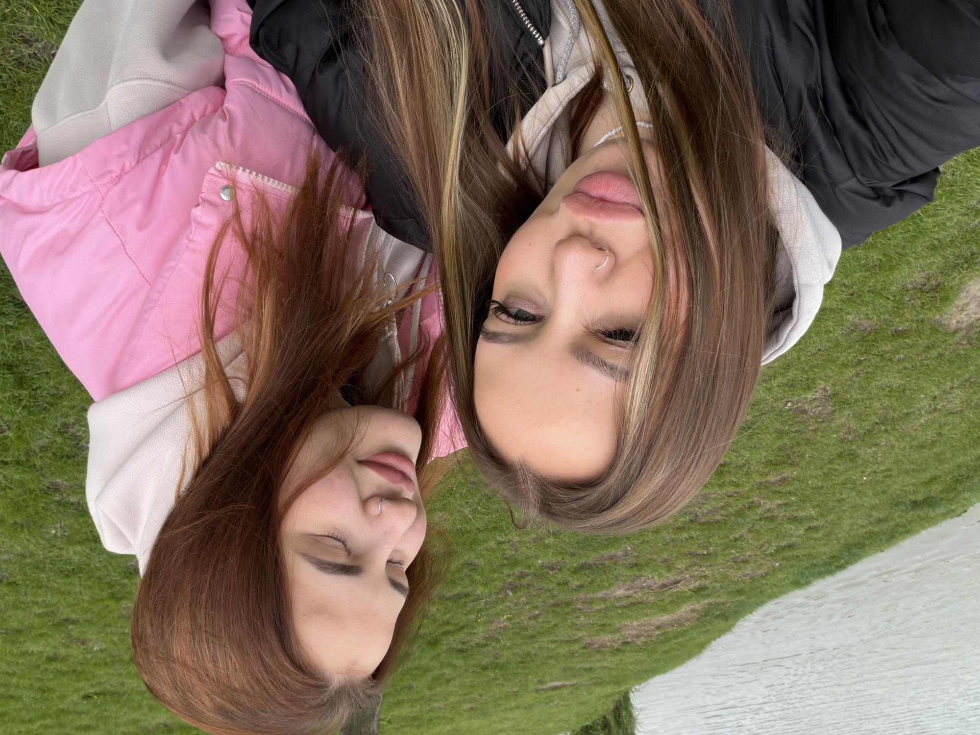 Two women photographed lying on grass in Krasnodar