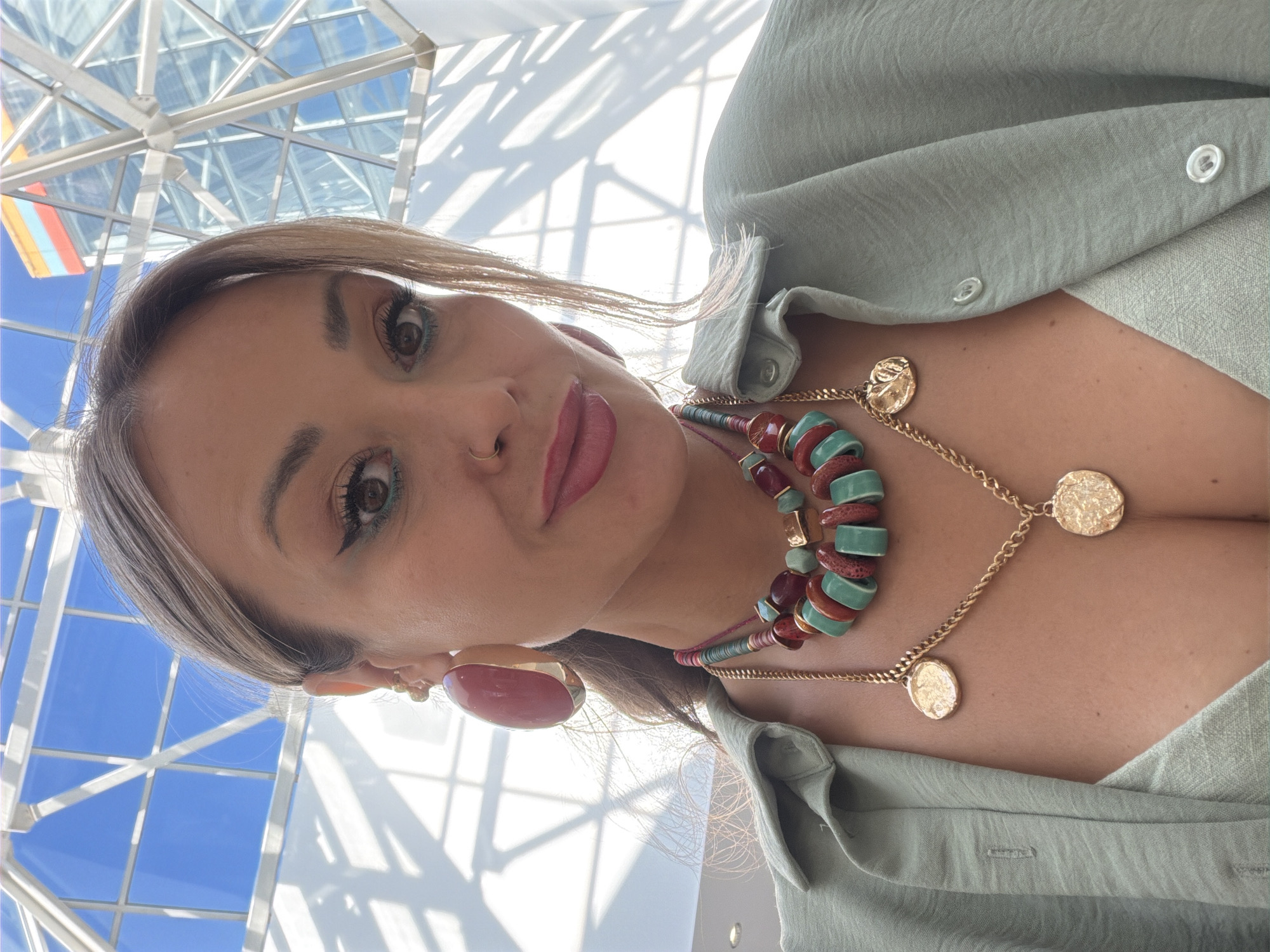 Selfie series in Krasnoyarsk featuring green tops and bold jewelry